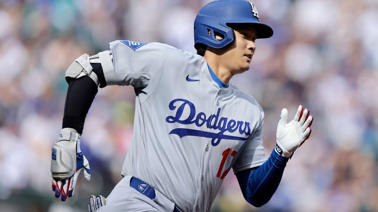 Los Angeles Dodgers Shohei Ohtani runs toward first base as he doubles against the Seattle Mariners during a baseball game, Sunday, Sept. 28, 2025, in Seattle.