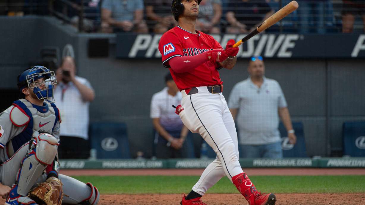 Cleveland Guardians' Brayan Rocchio, right, watches his walk off three-run home run off Texas Rangers relief pitcher Jose Corniell as Jonah Heim, left, watches during the tenth inning of a baseball game, Sunday, Sept. 28, 2025, in Cleveland.