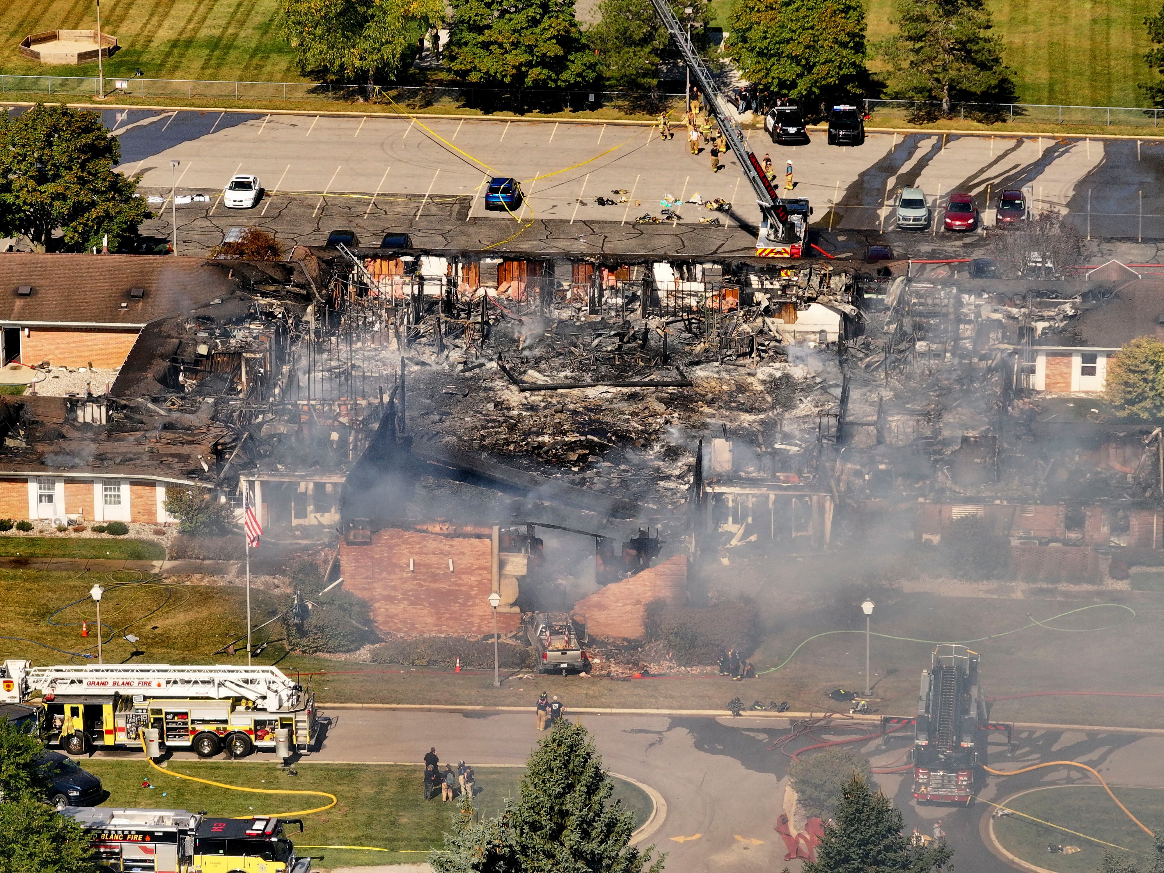 Emergency crews respond to a shooting and fire at The Church of Jesus Christ of Latter-day Saints in Grand Blanc, Mich., on Sunday.