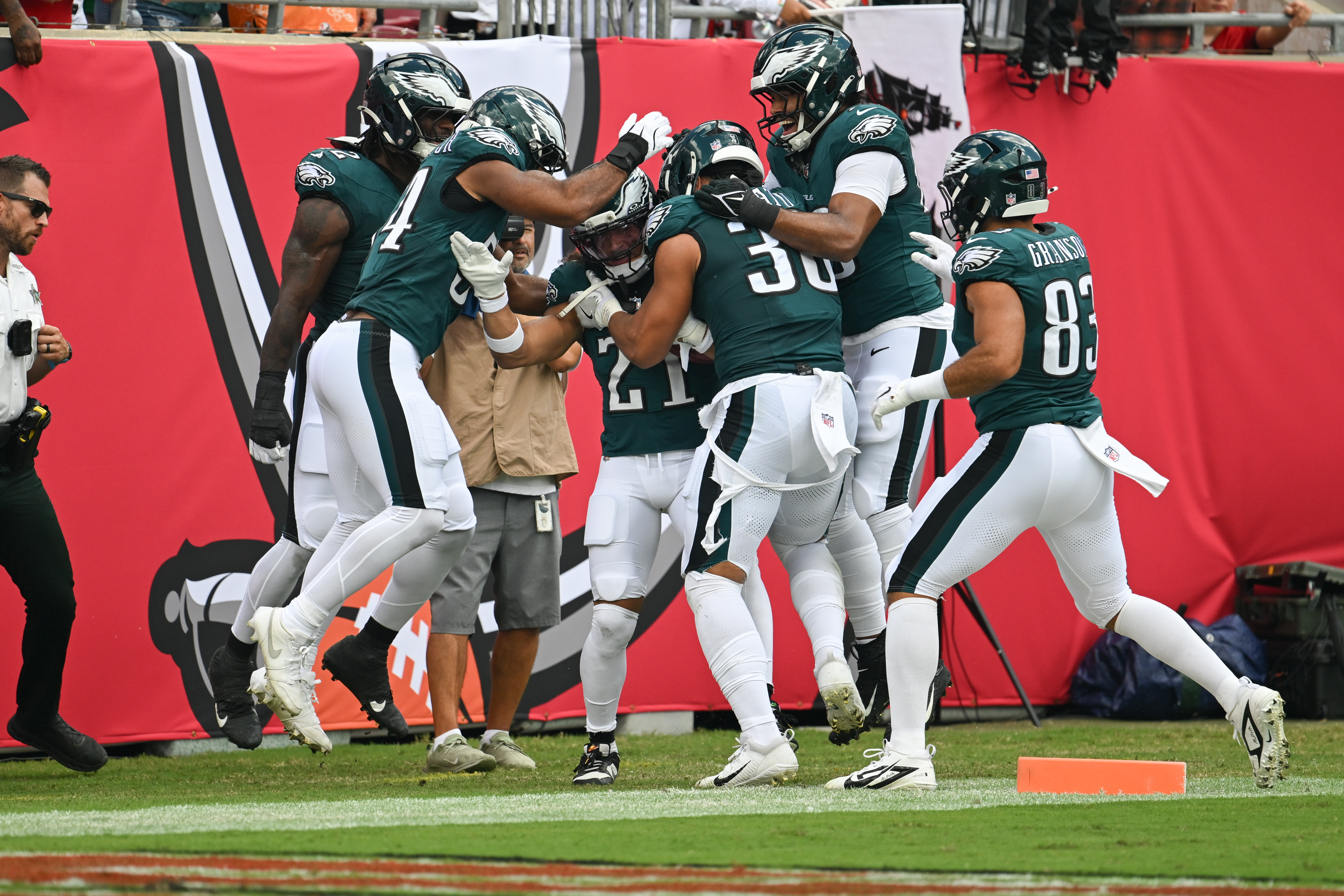 Philadelphia Eagles teammates surround safety Sydney Brown (21) as they celebrate his touchdown during the first half of an NFL football game against the Tampa Bay Buccaneers, Sunday, Sept. 28, 2025, in Tampa, Fla. 