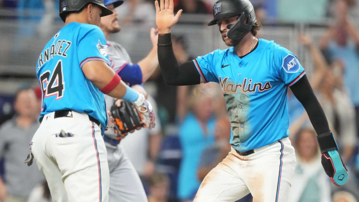 Miami Marlins' Connor Norby, right, is met by Heriberto Hernandez (64) after scoring on a double hit by Eric Wagaman during the fourth inning of a baseball game against the New York Mets1, Sunday, Sept. 28, 2025, in Miami.