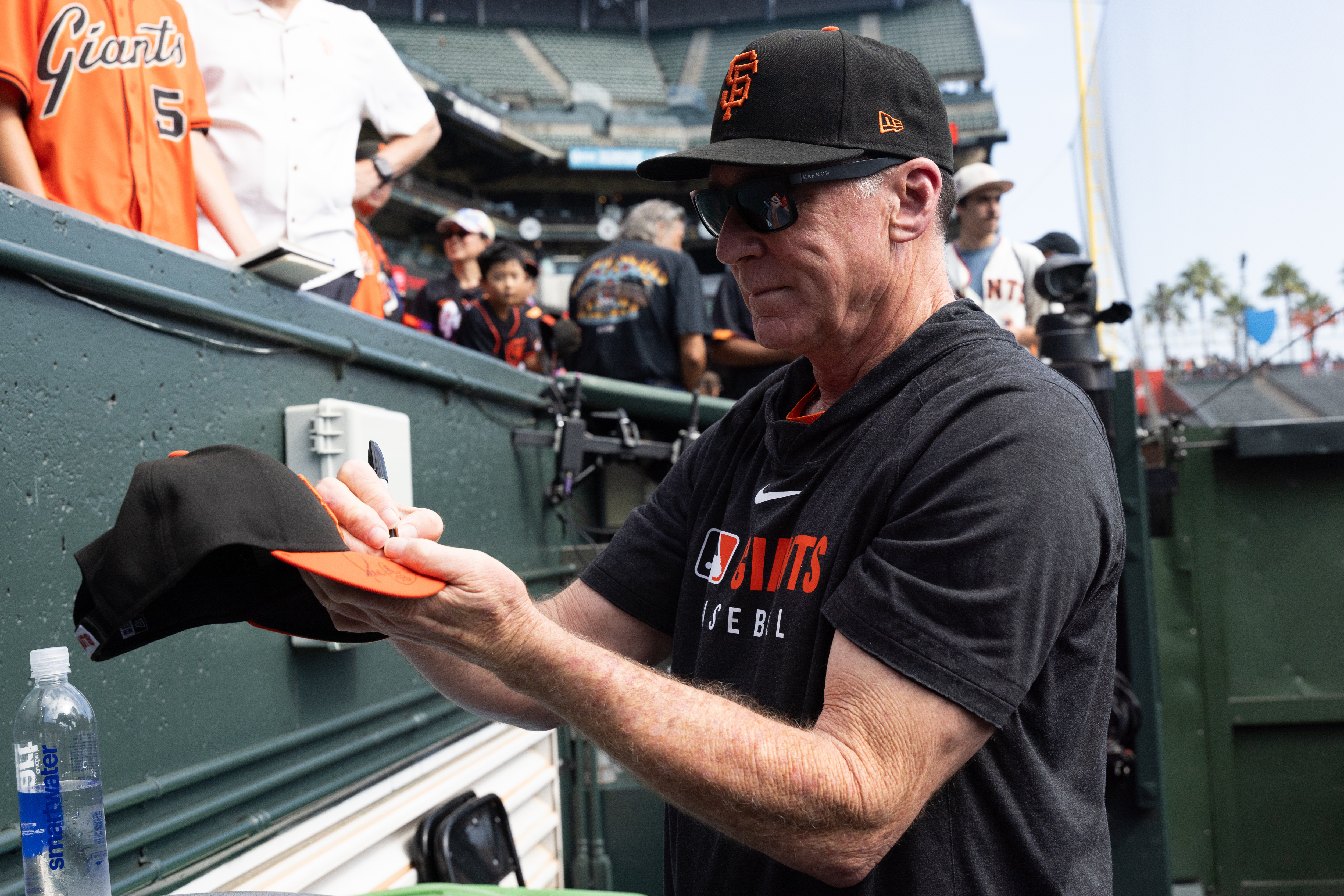 San Francisco Giants manager Bob Melvin gives out autographs before an MLB baseball game against the Colorado Rockies, Saturday, Sept. 27, 2025, in San Francisco.