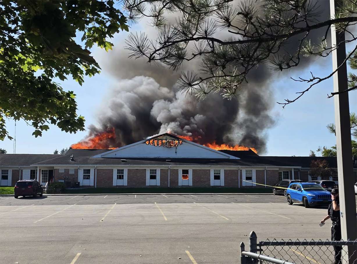 Fire rages at a meetinghouse of The Church of Jesus Christ of Latter-days Saints where a shooting and fire happened in Grand Blanc Township, Michigan, on Sunday.