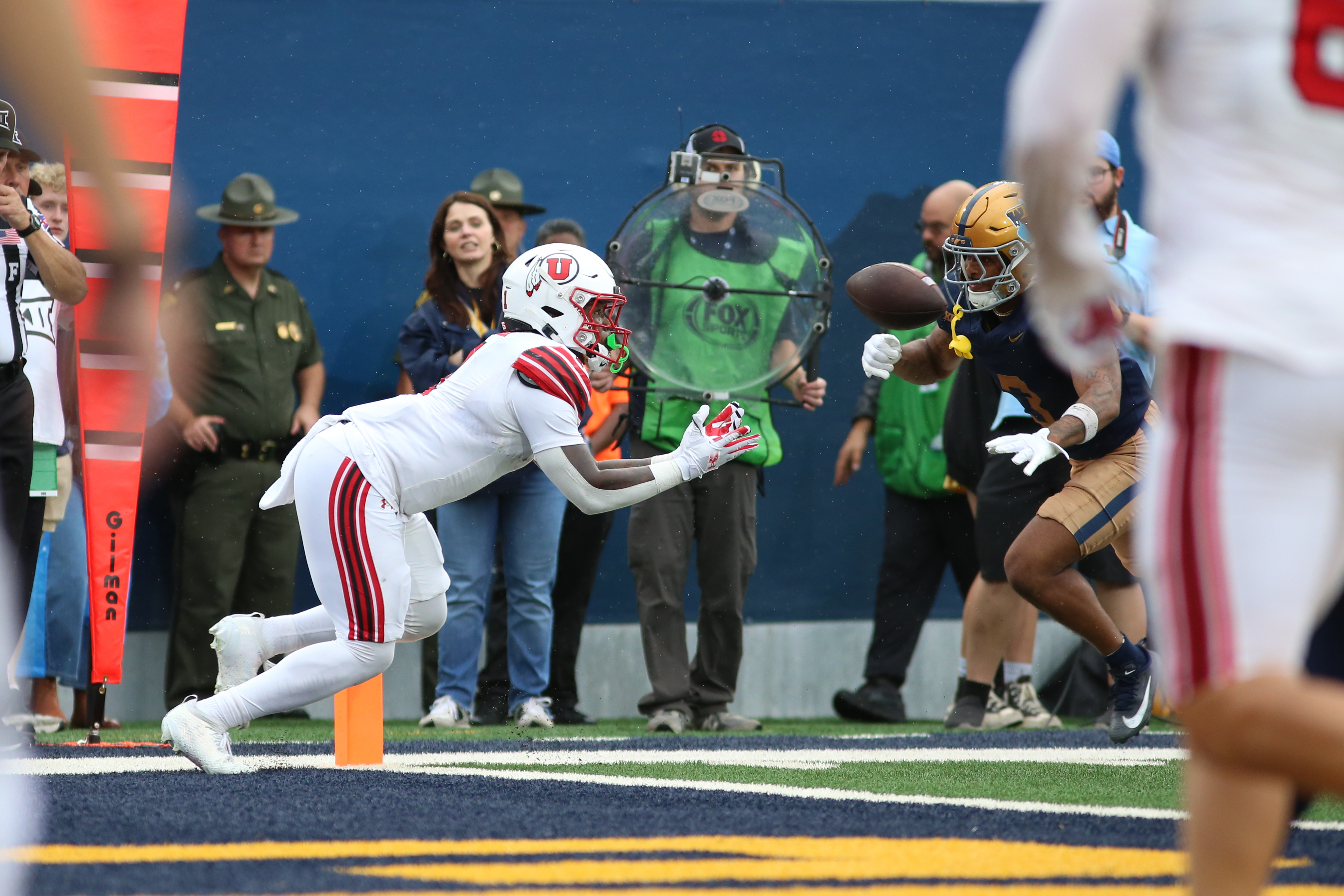 Utah running back Wayshawn Parker (1) makes a catch for a touchdown during the second half of an NCAA college football game against West Virginia, Saturday, Sept, 27, 2025, in Morgantown, W.Va.
