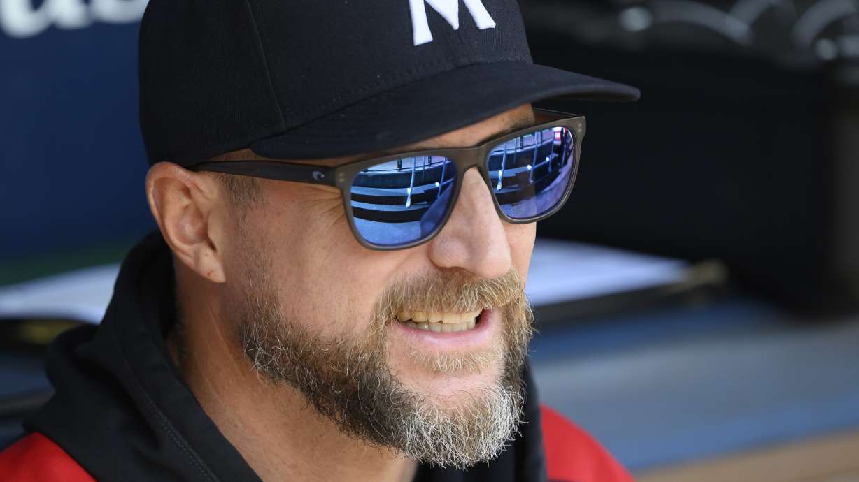 Minnesota Twins manager Rocco Baldelli talks to one of his players before a baseball game against the Kansas City Royals in Kansas City, Mo., Sunday, Sept. 7, 2025.