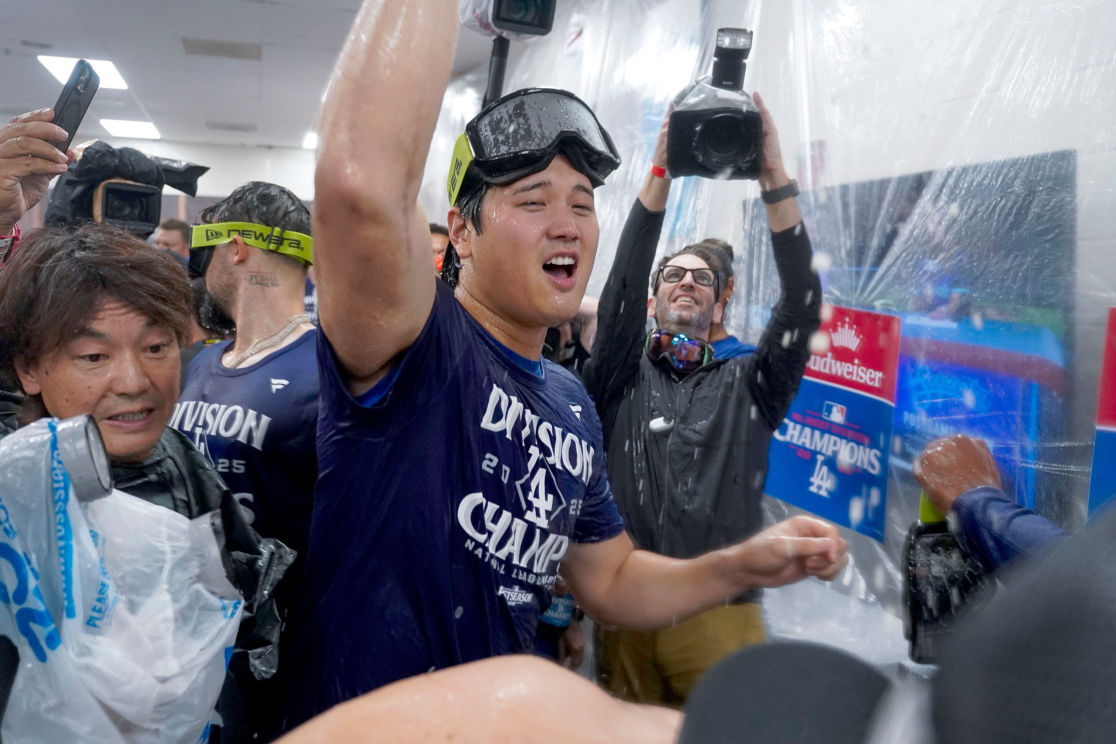 Los Angeles Dodgers two-way player Shohei Ohtani (17) center, celebrates after the Dodgers clinched the National League West title against the Arizona Diamondbacks during a baseball game at Chase Field Thursday, Sept. 25, 2025, in Phoenix. 