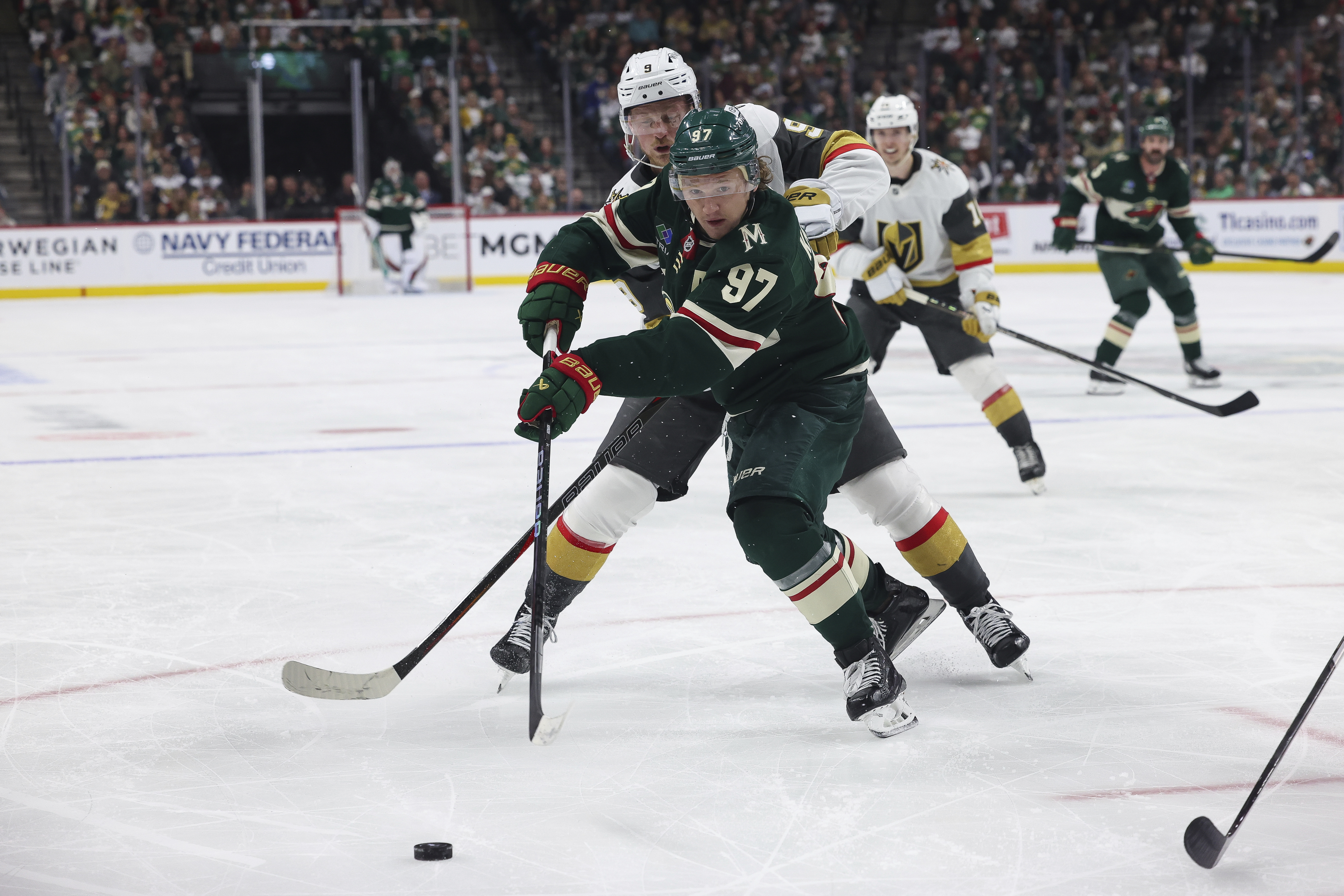 FILE - Minnesota Wild left wing Kirill Kaprizov (97) fights for the puck against Vegas Golden Knights center Jack Eichel (9) during the third period in Game 4 of an NHL hockey Stanley Cup first-round playoff series April 26, 2025, in St. Paul, Minn. Vegas won 4-3 in overtime. 