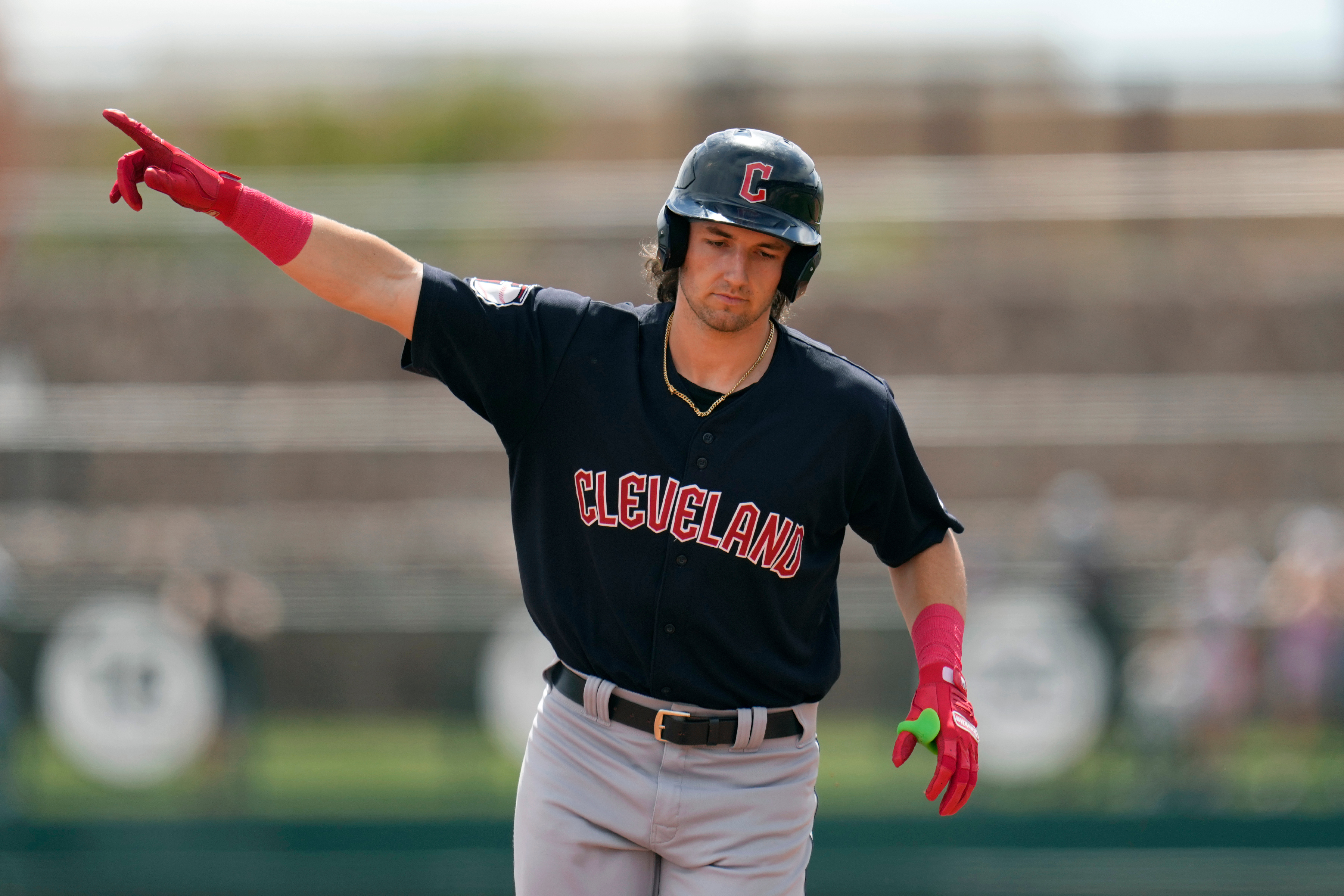 FILE - Cleveland Guardians' Chase DeLauter points as he rounds the bases after hitting a three-run home run against the Chicago White Sox during the first inning of a spring training baseball game, March 18, 2024, in Phoenix. 