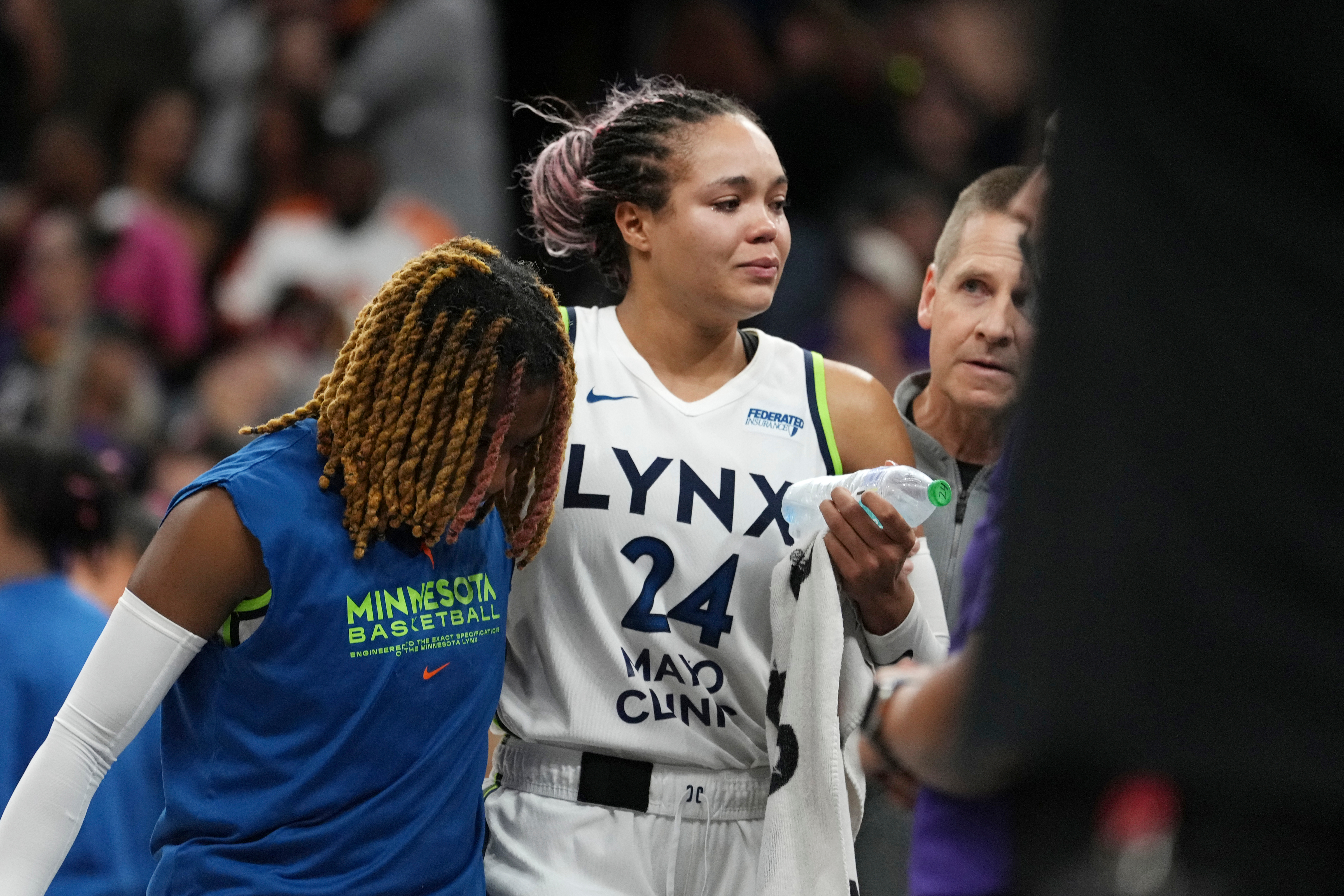 An injured Minnesota Lynx forward Napheesa Collier is helped off the court during the second half of Game 3 of a WNBA basketball playoff semifinals series game against the Phoenix Mercury Friday, Sept. 26, 2025, in Phoenix.