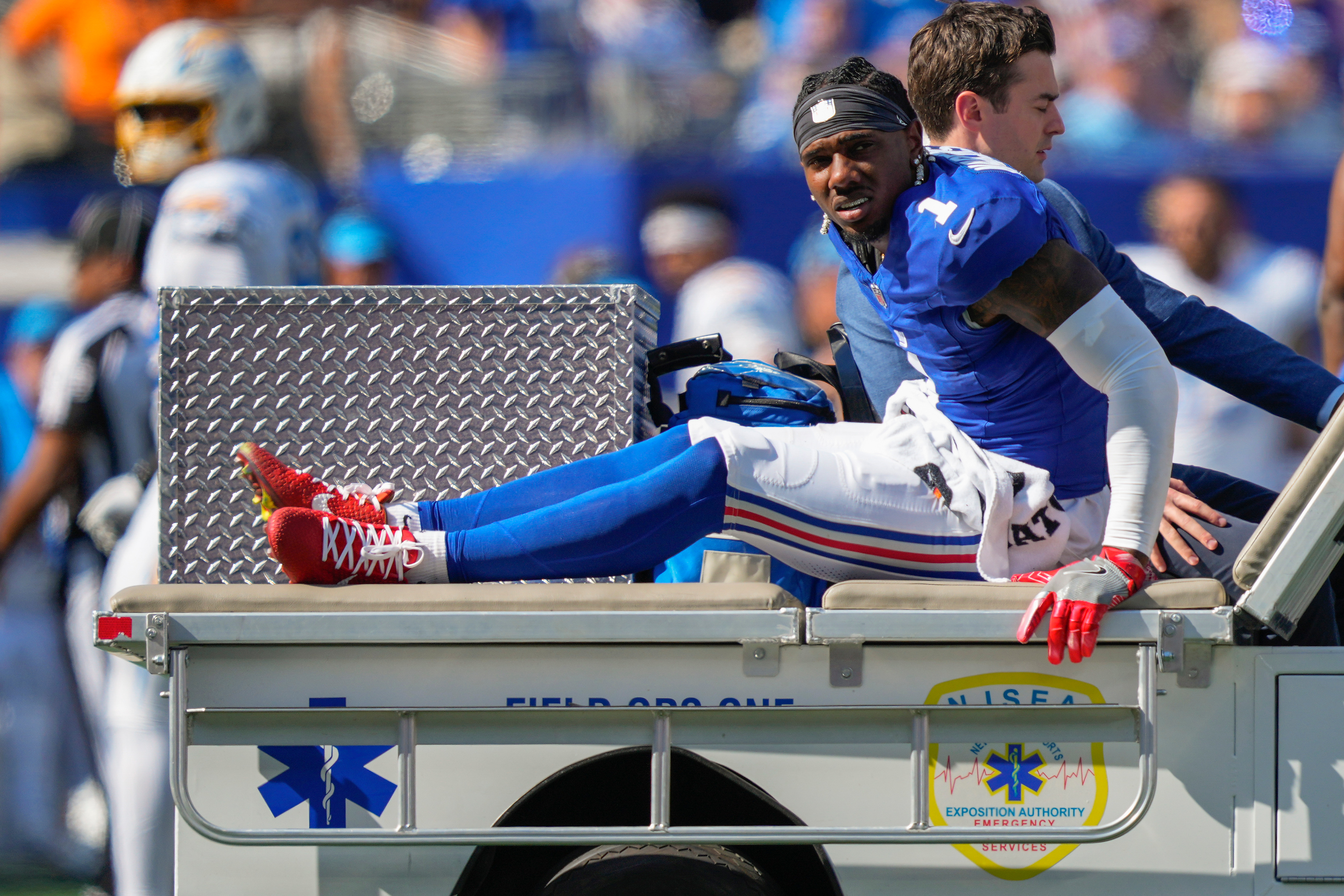 New York Giants wide receiver Malik Nabers (1) is driven off the field by medical personnel after an injury during the second quarter of an NFL football game against the Los Angeles Chargers, Sunday, Sept. 28, 2025, in East Rutherford, N.J. 