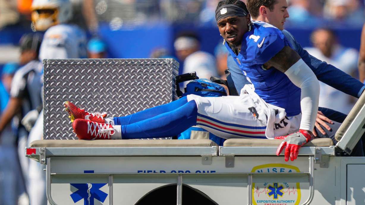 New York Giants wide receiver Malik Nabers (1) is driven off the field by medical personnel after an injury during the second quarter of an NFL football game against the Los Angeles Chargers, Sunday, Sept. 28, 2025, in East Rutherford, N.J.