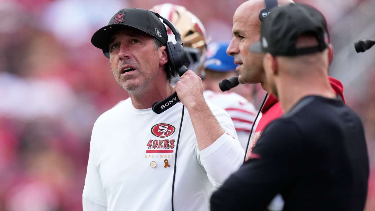 San Francisco 49ers head coach Kyle Shanahan, left, reacts next to defensive coordinator Robert Saleh, middle, during the first half of an NFL football game against the Jacksonville Jaguars in Santa Clara, Calif., Sunday, Sept. 28, 2025.