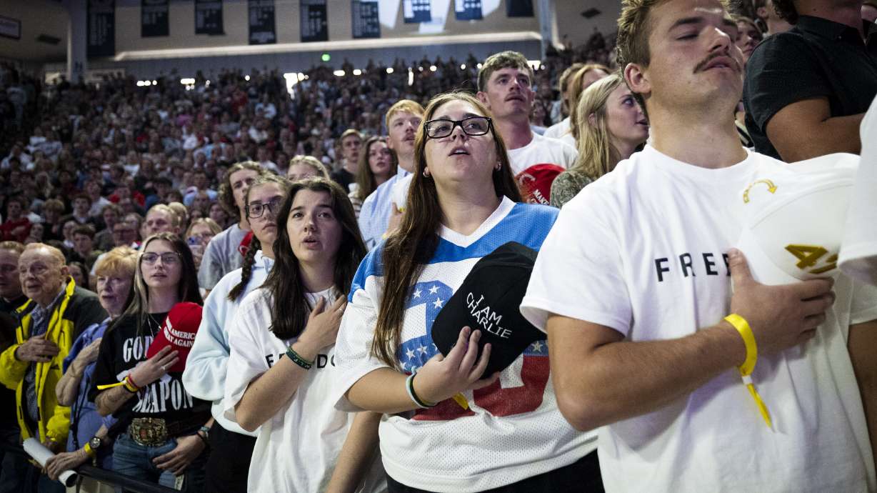 Elizabeth Brown, second from right, of Gilbert, Ariz., sings “The Star-Spangled Banner” with the crowd at the start of a stop on the “This Is The Turning Point” tour held by Turning Point USA at the Dee Glen Smith Spectrum on the campus of Utah State University in Logan on Tuesday.