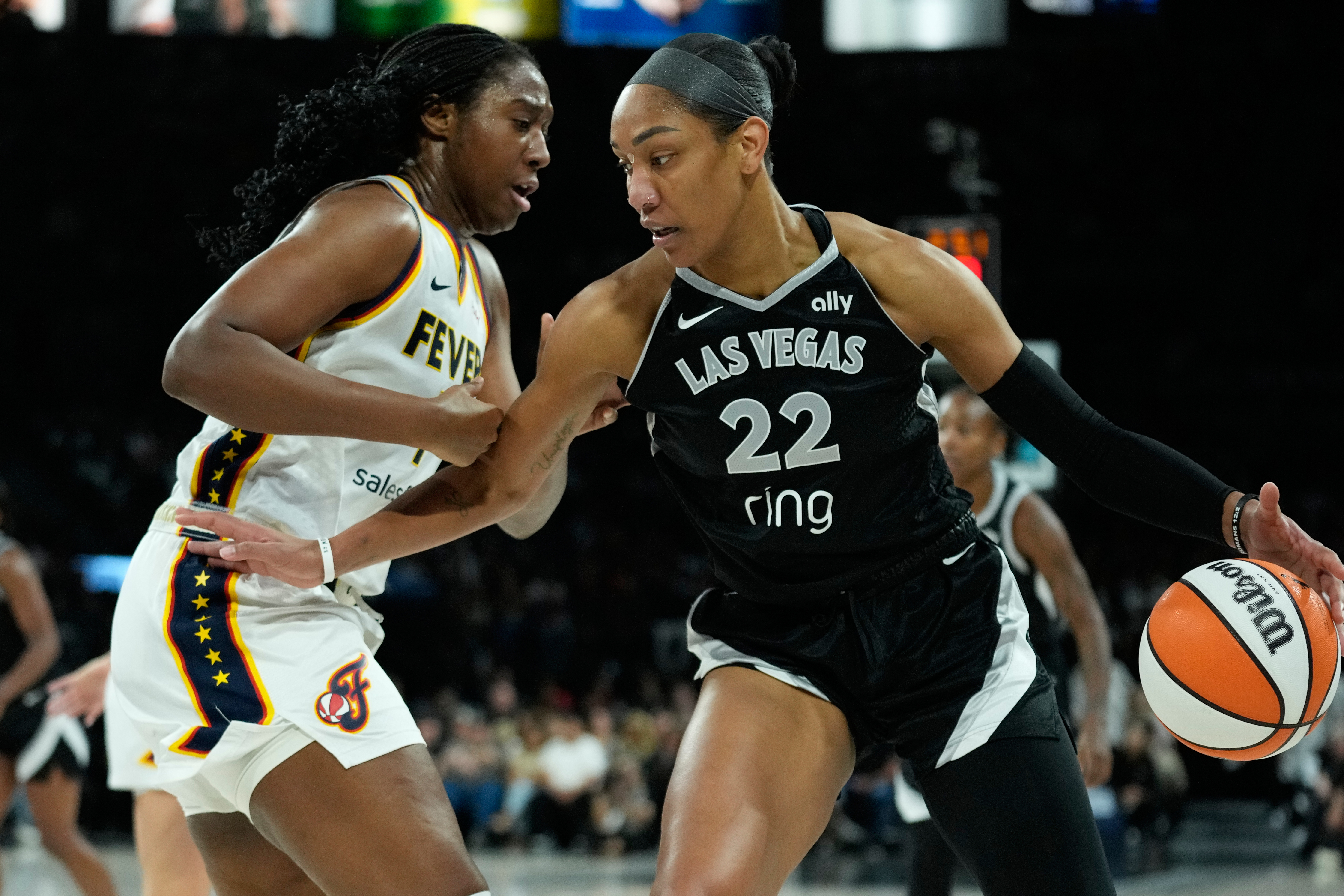 Las Vegas Aces center A'ja Wilson (22) drives against Indiana Fever forward Aliyah Boston (7) during the first half of Game 5 of a WNBA basketball playoff semifinals series Tuesday, Sept. 30, 2025, in Las Vegas. 