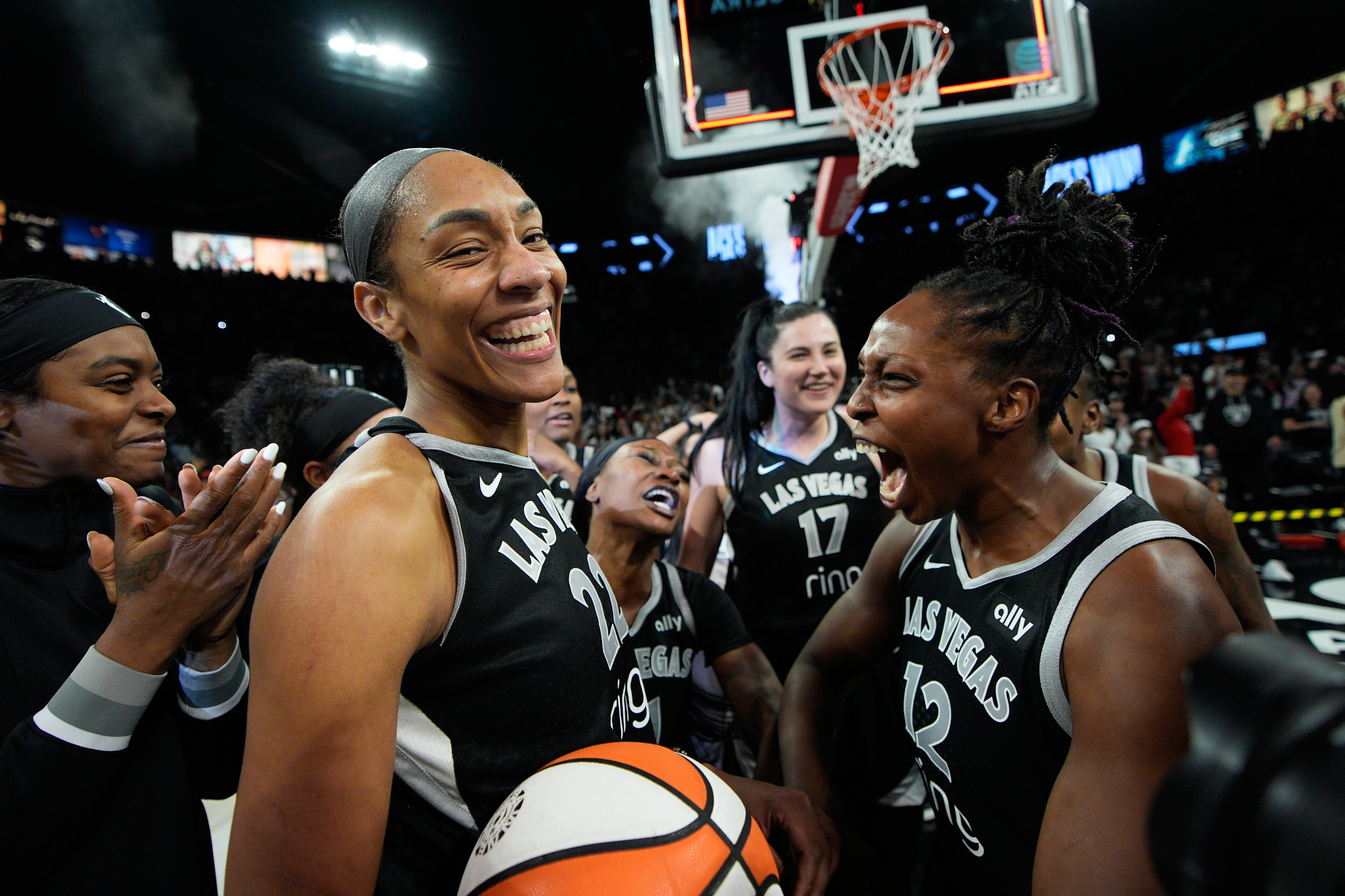 Las Vegas Aces center A'ja Wilson (22) and Las Vegas Aces guard Chelsea Gray (12) celebrate after the Las Vegas Aces defeated the Indiana Fever in Game 5 of a WNBA basketball playoff semifinals series Tuesday, Sept. 30, 2025, in Las Vegas. 