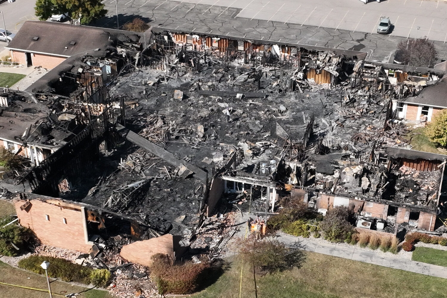 Little remains of a Church of Jesus Christ of Latter-day Saints chapel the day after a former Marine opened fire and set the building ablaze in Grand Blanc Township, Mich., Monday.