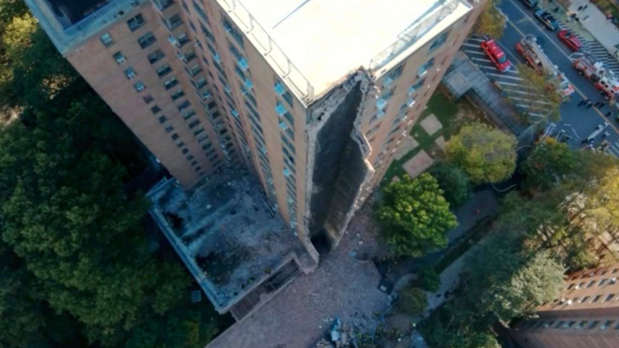 Part of a high-rise apartment building collapsed, leaving a corner of the building in a pile of rubble, in New York, Wednesday.