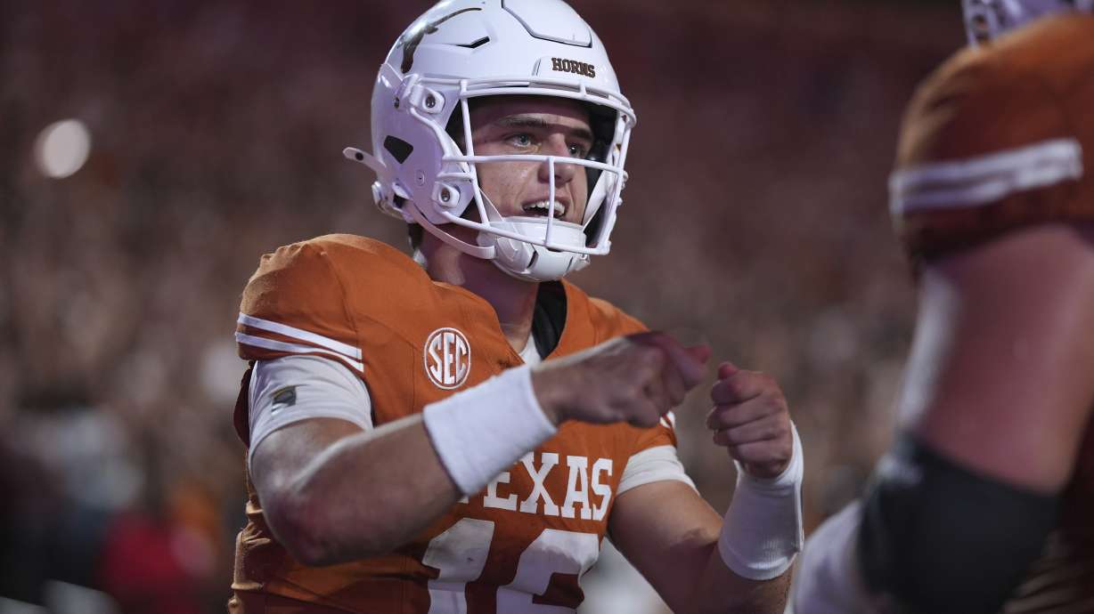 Texas quarterback Arch Manning (16) celebrates with teammates after he scored a touchdown against Sam Houston State during the first half of an NCAA college football game in Austin, Texas, Saturday, Sept. 20, 2025.