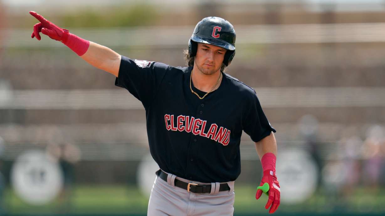 FILE - Cleveland Guardians' Chase DeLauter points as he rounds the bases after hitting a three-run home run against the Chicago White Sox during the first inning of a spring training baseball game, March 18, 2024, in Phoenix.