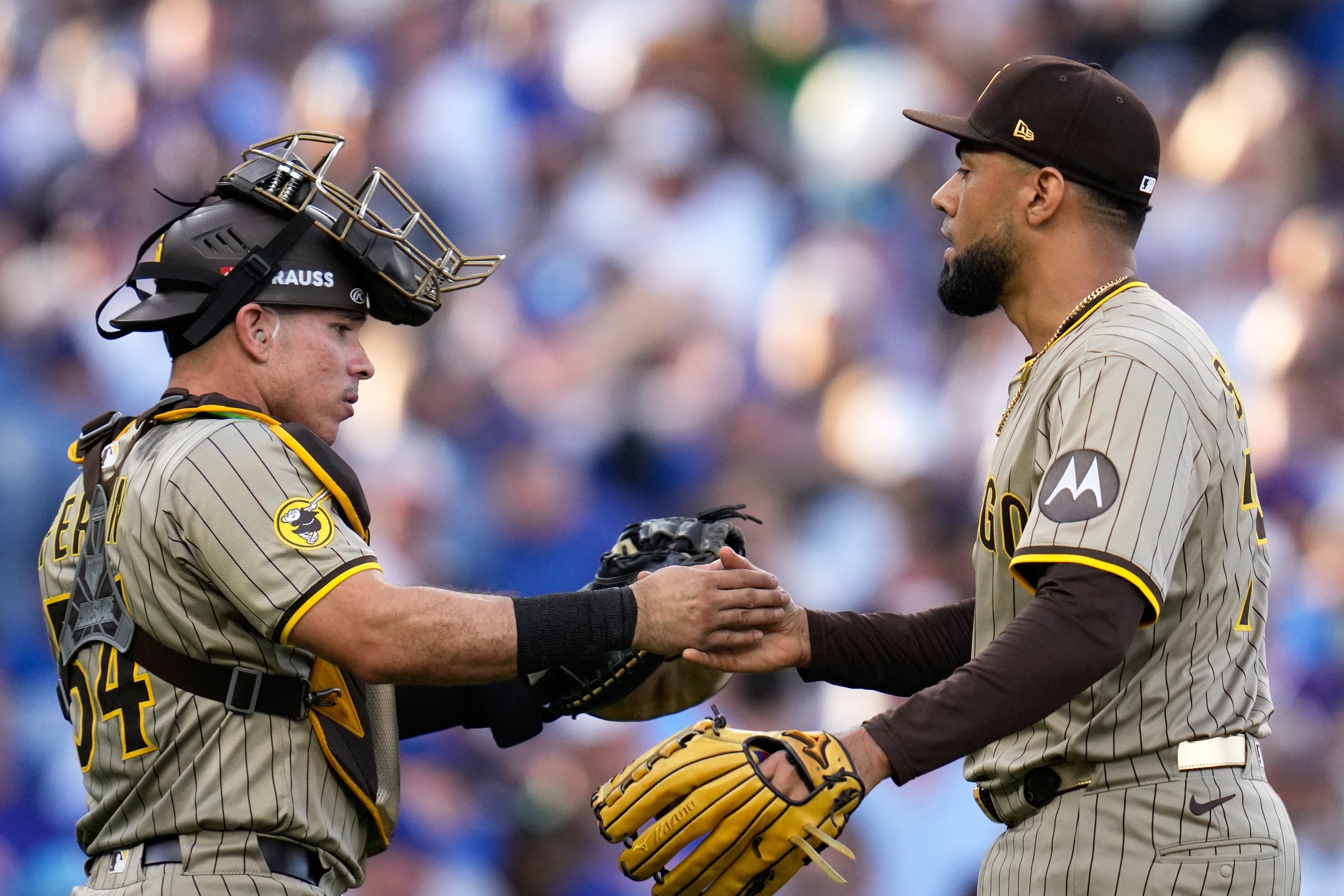 San Diego Padres' Robert Suarez and Freddy Fermin celebrate after Game 2 of a National League wild card baseball game against the Chicago Cubs Wednesday, Oct. 1, 2025, in Chicago.