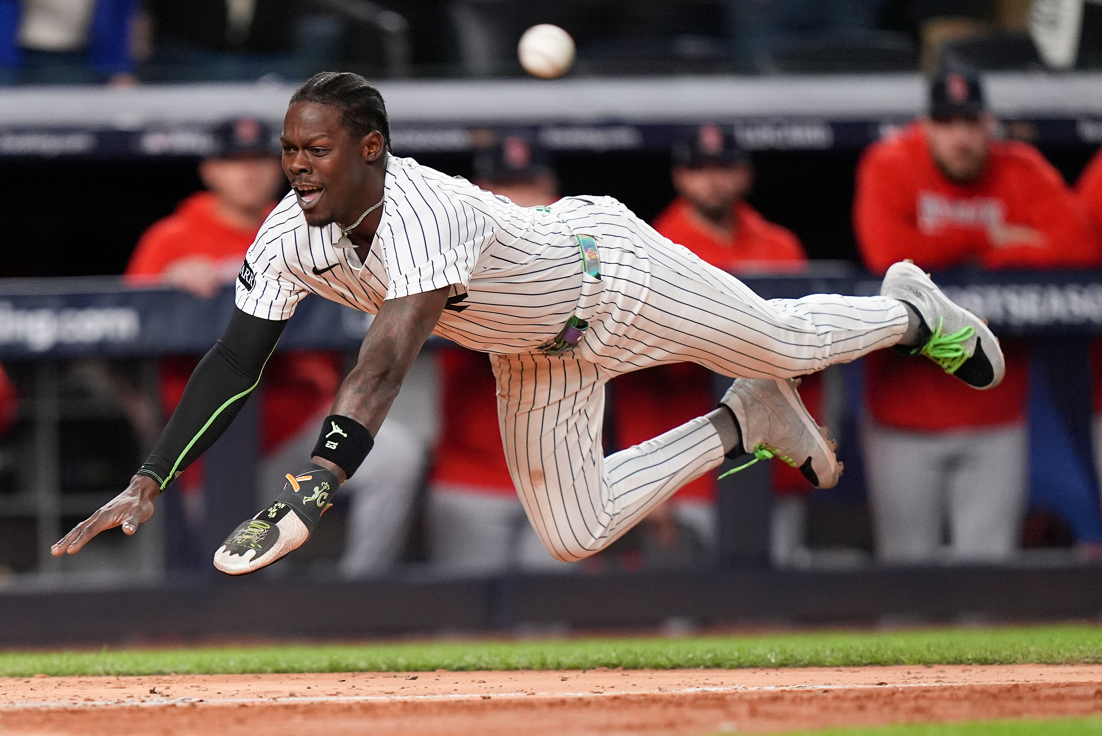 New York Yankees Jazz Chisholm Jr. dives into home plate to score on a hit by Austin Wells against the Boston Red Sox during the eighth inning of Game 2 of an American League wild-card baseball playoff series, Wednesday, Oct. 1, 2025, in New York. 