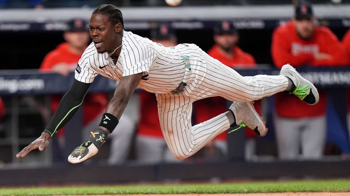 New York Yankees Jazz Chisholm Jr. dives into home plate to score on a hit by Austin Wells against the Boston Red Sox during the eighth inning of Game 2 of an American League wild-card baseball playoff series, Wednesday, Oct. 1, 2025, in New York.