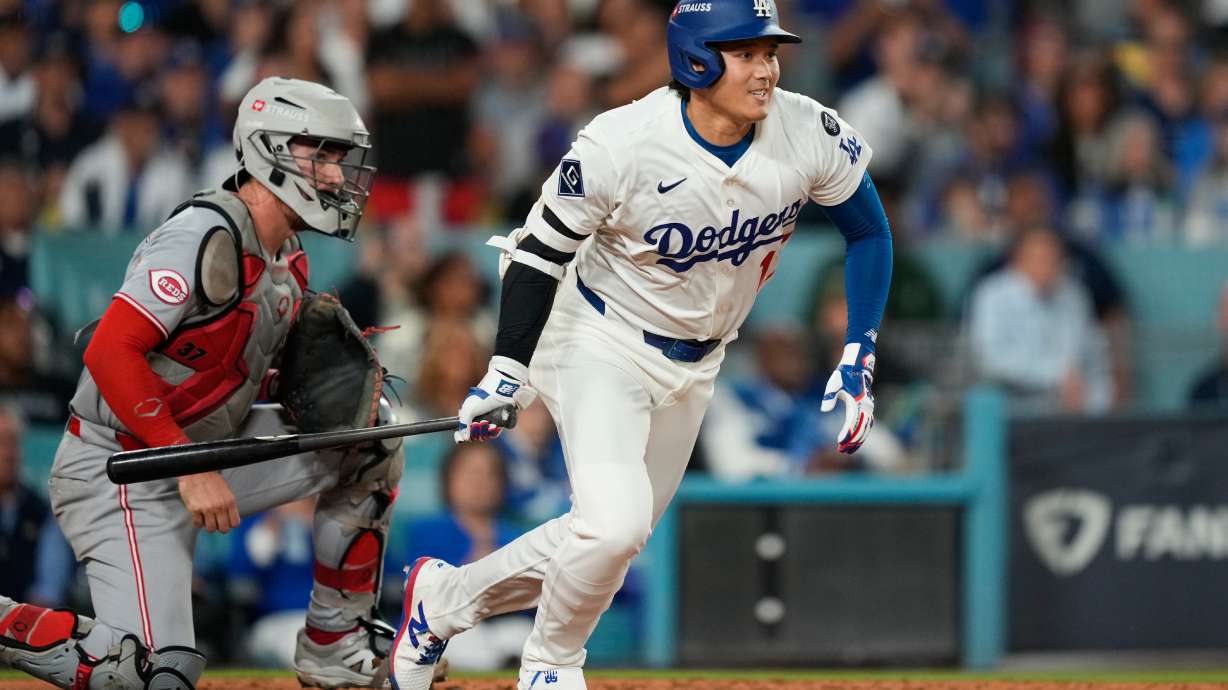 Los Angeles Dodgers' Shohei Ohtani follows through on an RBI single during the sixth inning in Game 2 of the National League Wild Card baseball playoff series against the Cincinnati Reds, Wednesday, Oct. 1, 2025, in Los Angeles.