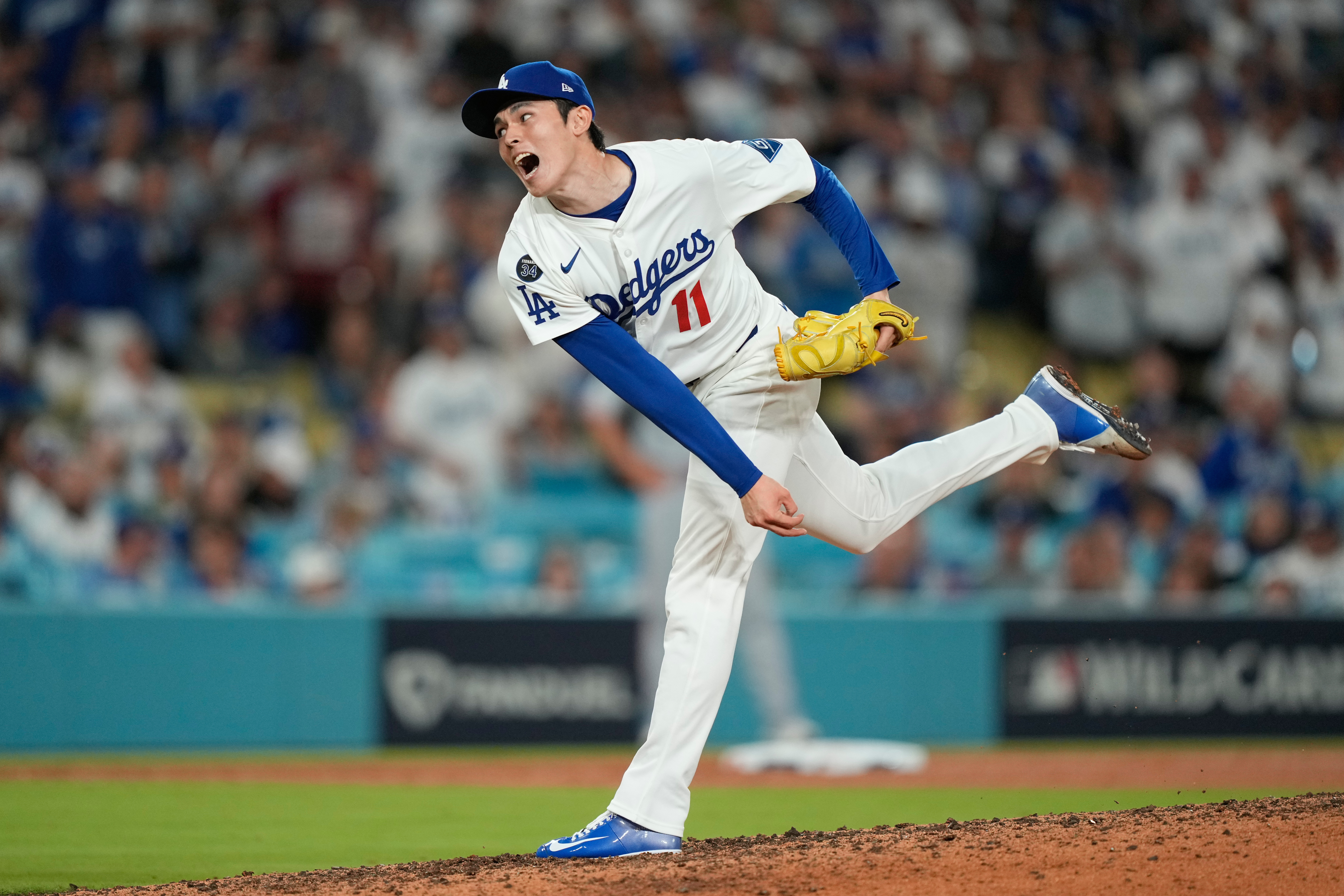 Los Angeles Dodgers relief pitcher Roki Sasaki throws to a Cincinnati Reds batter during the ninth inning in Game 2 of the National League Wild Card baseball playoff series Wednesday, Oct. 1, 2025, in Los Angeles. 