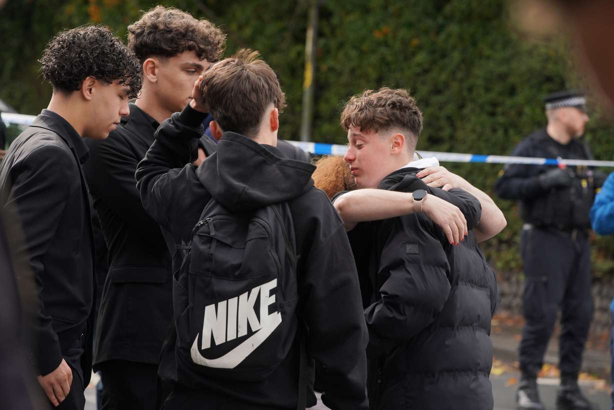 People react near to the scene of a stabbing incident in Crumpsall, Manchester, England, Thursday. An assailant killed two people and wounded four others in what police described as a terrorist attack on the Heaton Park Hebrew Congregation synagogue.