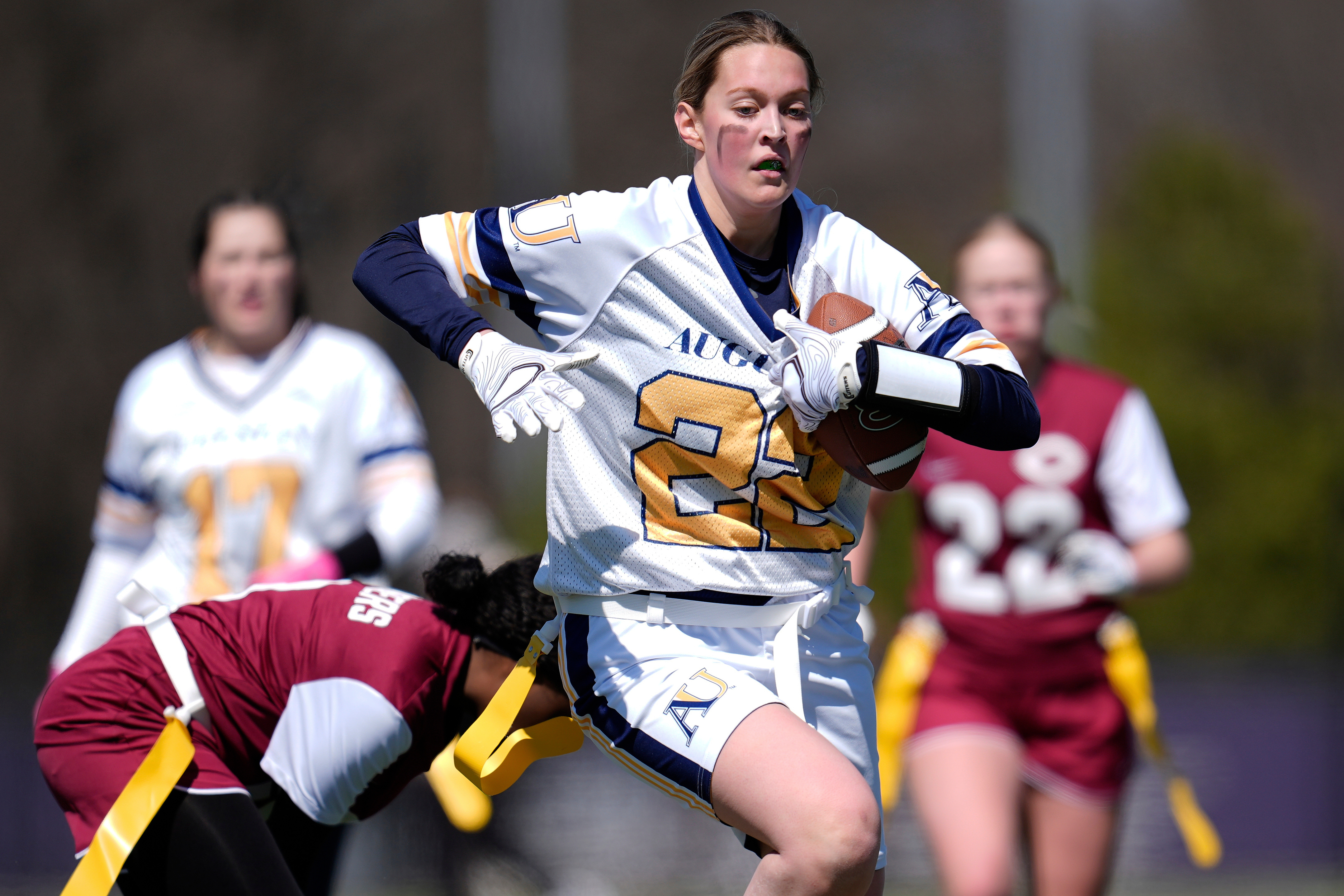 FILE - Augustana University and Concordia University, St. Paul players compete during a women's college flag football game, April 7, 2025, in St. Paul. Minn. 