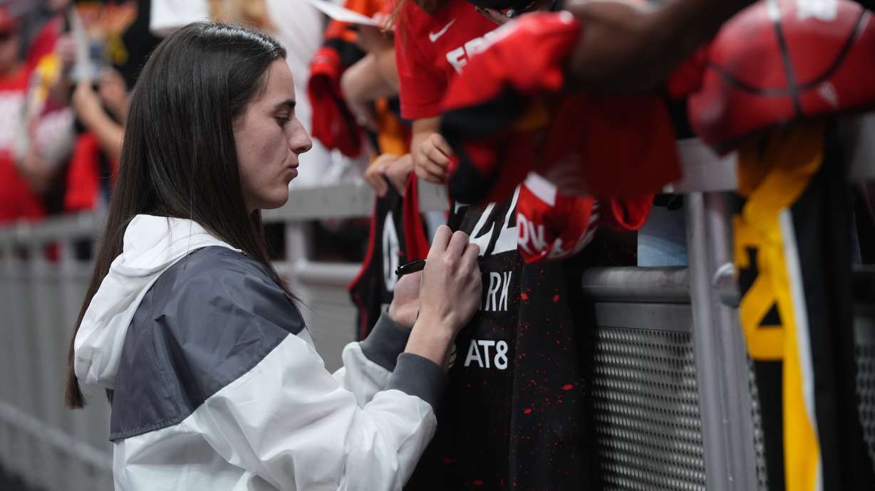 Indiana Fever's Caitlin Clark signs autographs before Game 3 of a WNBA basketball playoff semifinals series against the Las Vegas Aces, Friday, Sept. 26, 2025, in Indianapolis.