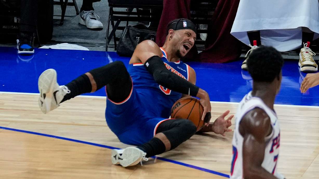 New York Knicks' Josh Hart reacts as he falls during the first half of an NBA preseason basketball game against the Philadelphia 76ers, Thursday, Oct. 2, 2025, in Abu Dhabi, United Arab Emirates.