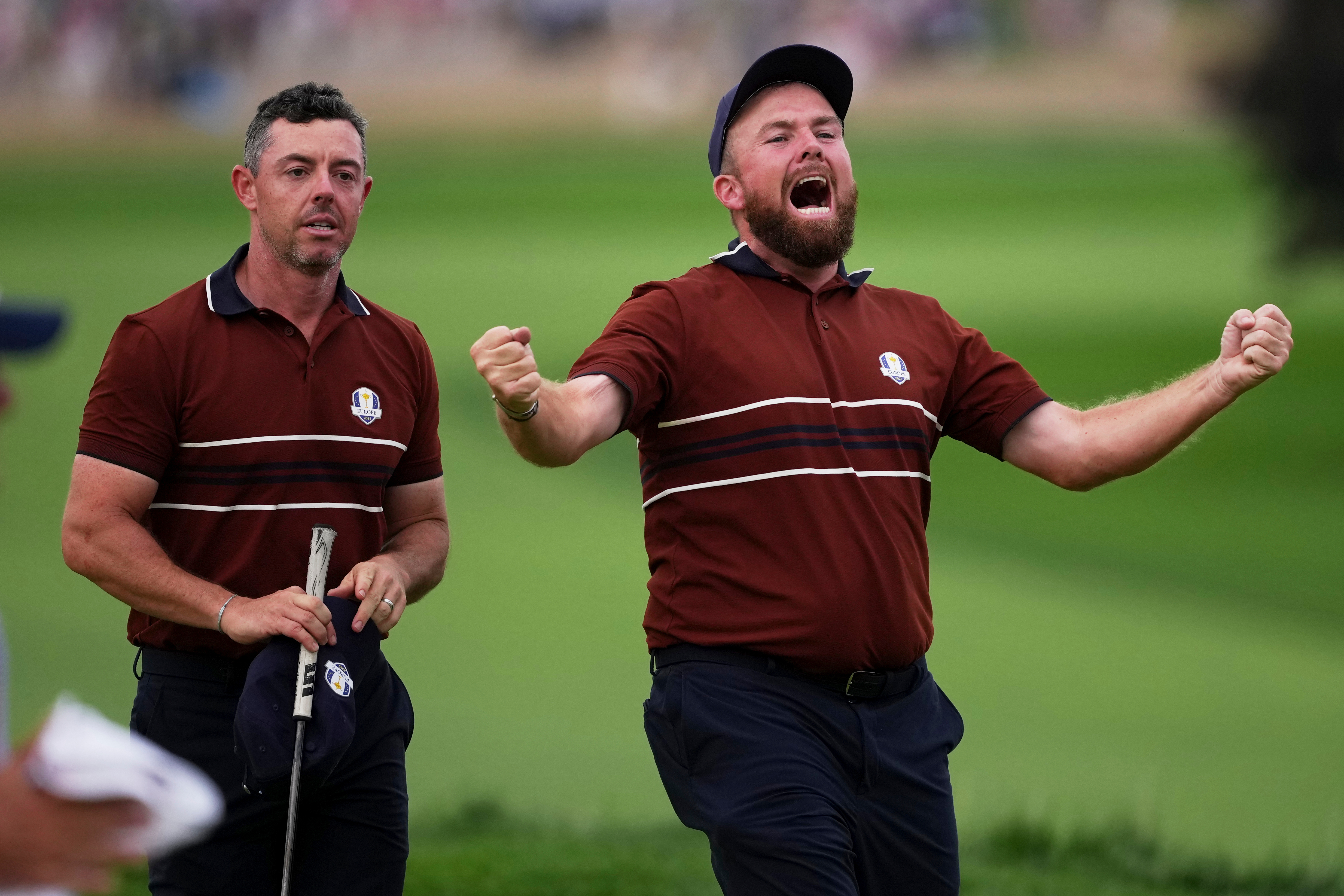 Europe's Shane Lowry and Rory McIlroy react after their match win on the 18th hole at Bethpage Black golf course during the Ryder Cup golf tournament, Saturday, Sept. 27, 2025, in Farmingdale, N.Y. 