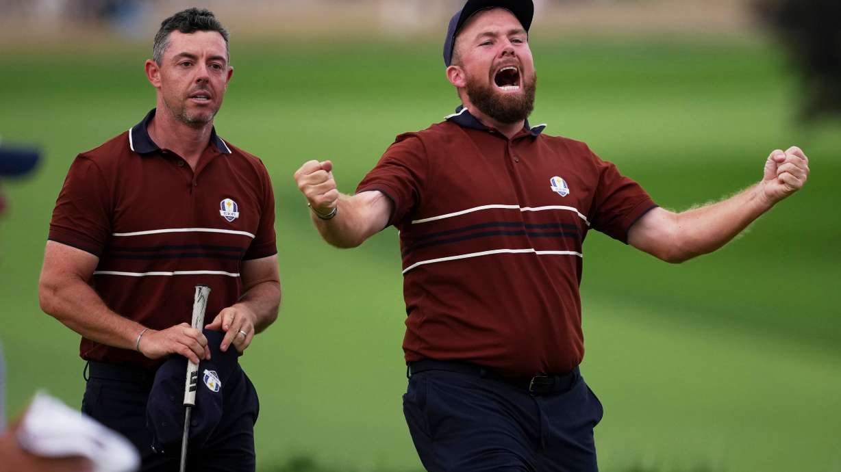 Europe's Shane Lowry and Rory McIlroy react after their match win on the 18th hole at Bethpage Black golf course during the Ryder Cup golf tournament, Saturday, Sept. 27, 2025, in Farmingdale, N.Y.
