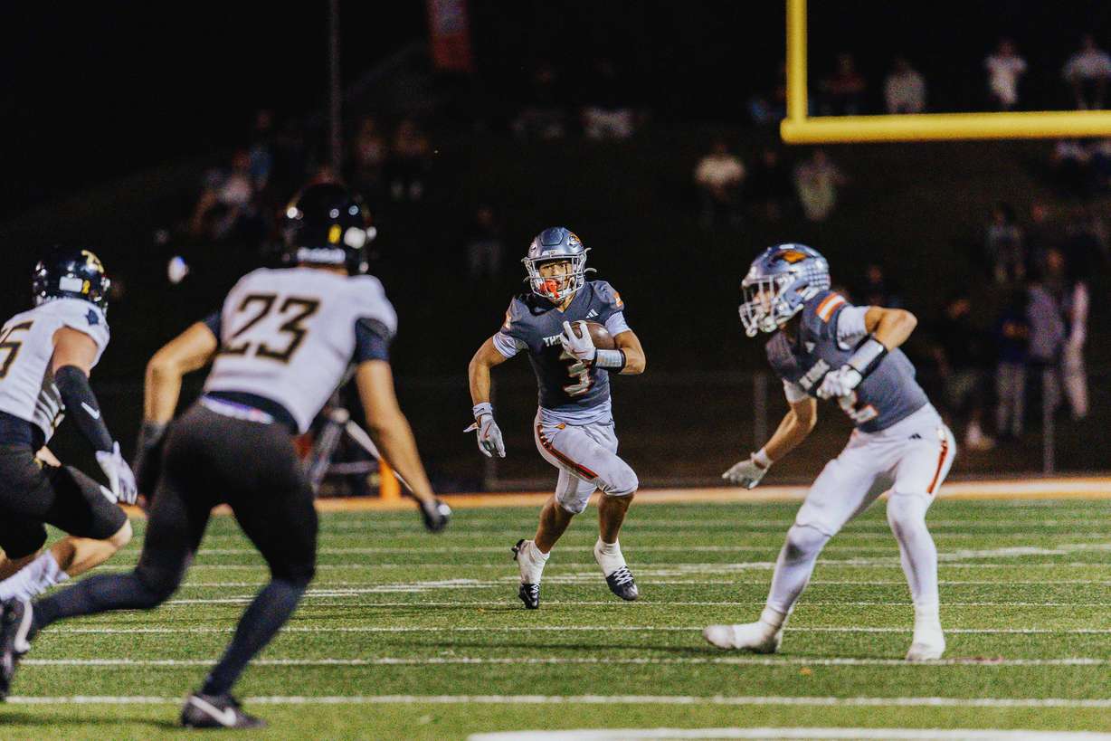 Skyridge's Lincoln Tahi runs the ball during a Utah high school football game, Thursday, Oct. 2, 2025 against Lone Peak in Lehi, Utah.