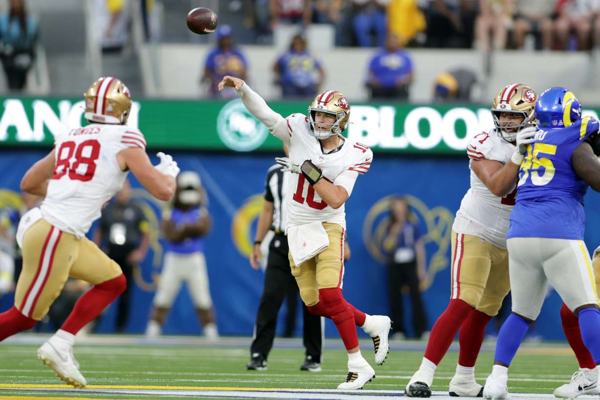 CORRECTS TO INGLEWOOD, CALIF., NOT LOS ANGELES - San Francisco 49ers' Mac Jones, center, throws a pass against the Los Angeles Rams during the first quarter of an NFL football game in Inglewood, Calif., Thursday, Oct. 2, 2025.