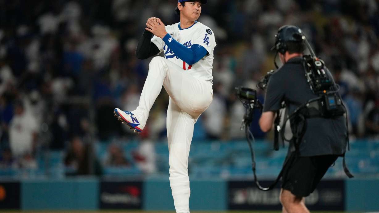 Los Angeles Dodgers' Shohei Ohtani makes a pitching motion on the mound after a win over the Cincinnati Reds in Game 1 of the National League Wild Card baseball playoff series Tuesday, Sept. 30, 2025, in Los Angeles.
