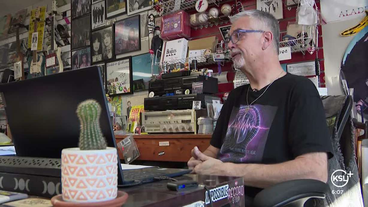 Michael Maccarrone, co-owner of Sound and Vision Vinyl in South Salt Lake, talks to KSL on Thursday. His store boasts a sizeable selection of Taylor Swift albums and posters.