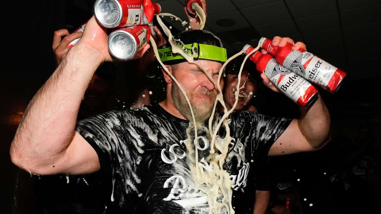 New York Yankees pitcher David Bednar (53) sprays himself with beer while celebrating with teammates after the Yankees defeated the Boston Red Sox in Game 3 of an American League wild-card baseball playoff series, Thursday, Oct. 2, 2025, in New York.