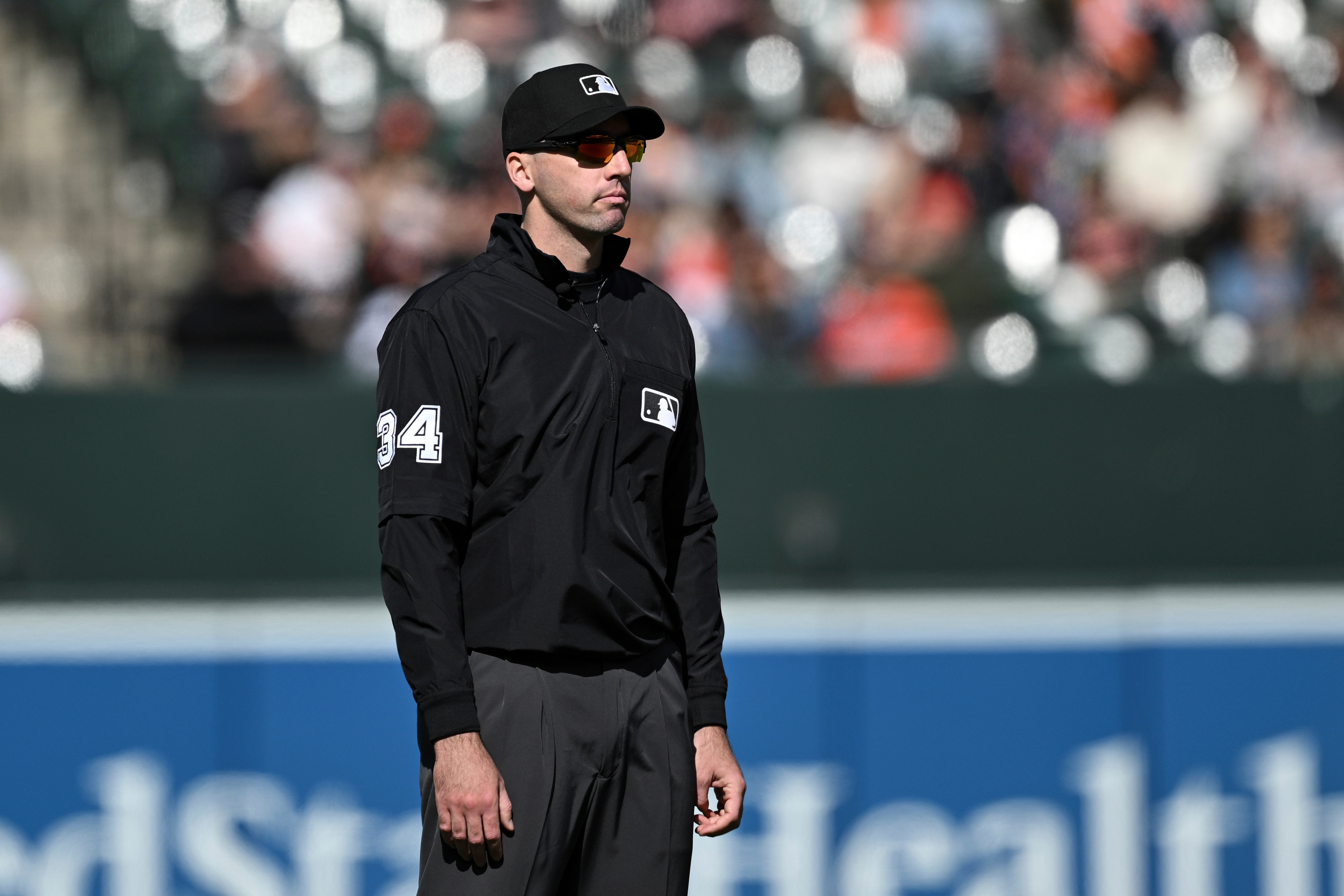 FILE - Umpire Nate Tomlinson looks on during a baseball game between the Baltimore Orioles and the Toronto Blue Jays in Baltimore, April 13, 2025. 
