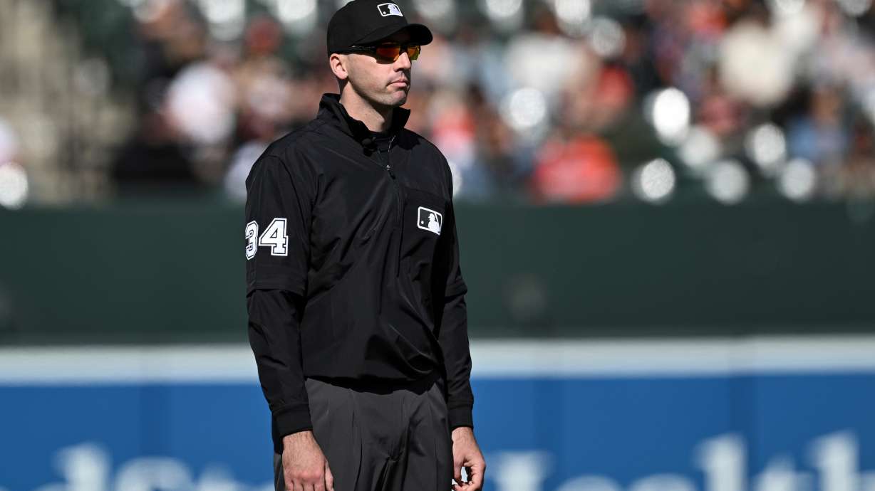 FILE - Umpire Nate Tomlinson looks on during a baseball game between the Baltimore Orioles and the Toronto Blue Jays in Baltimore, April 13, 2025.