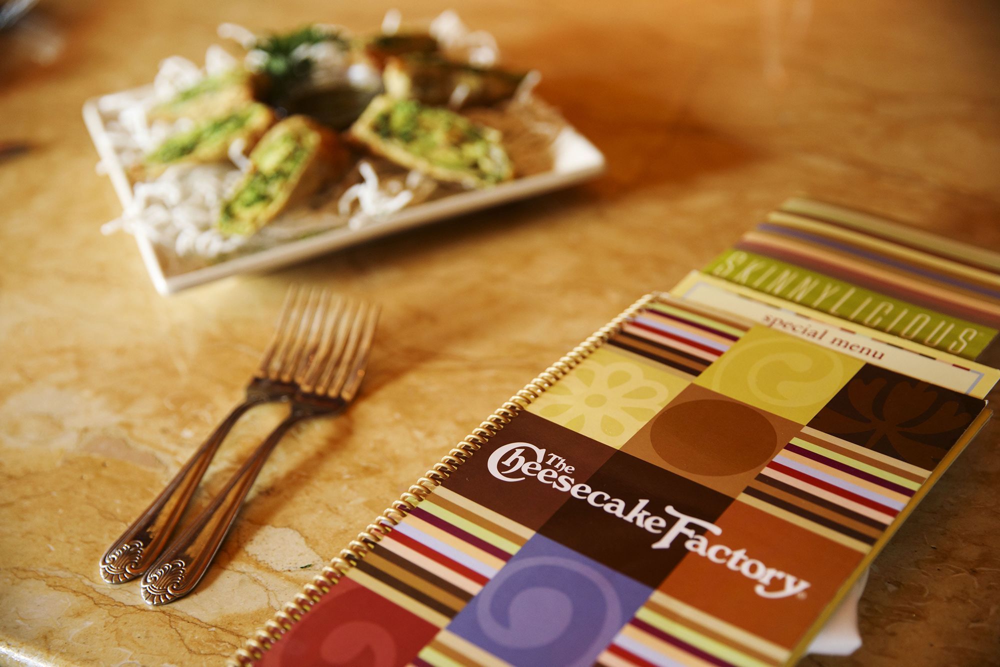 The Cheesecake Factory menu with its iconic avocado egg rolls. Olive Garden recently noticed some customers actually want less food.