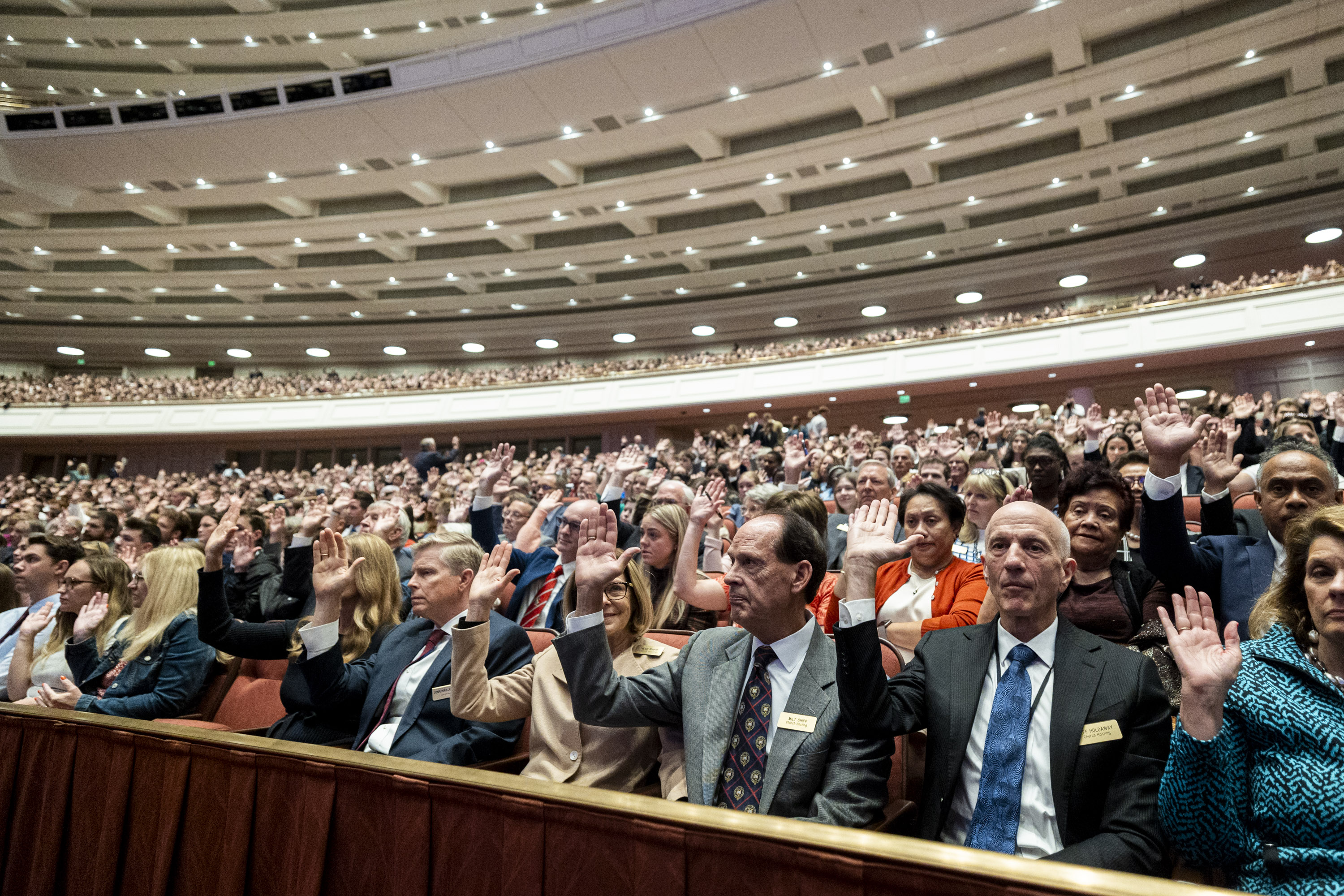 Conferencegoers raise their hands as part of a sustaining vote during the Saturday morning session of general conference of The Church of Jesus Christ of Latter-day Saints at the Conference Center in Salt Lake City on Oct. 4, 2025.
