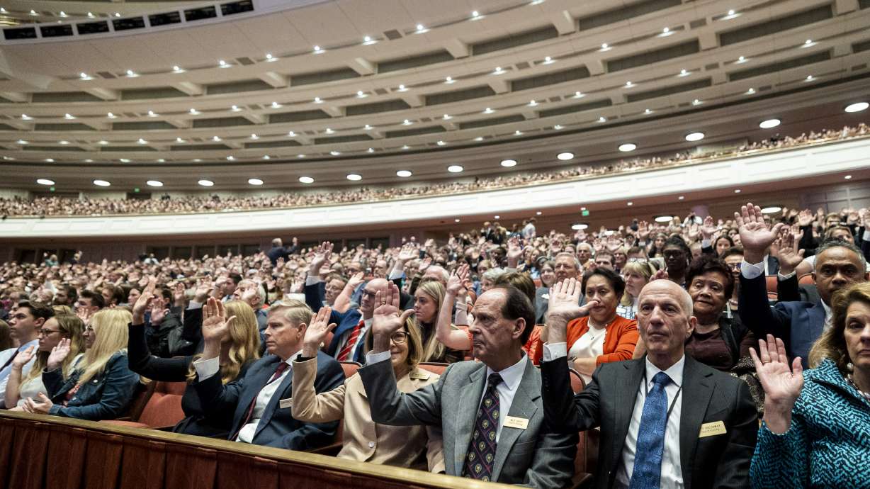 Conferencegoers raise their hands as part of a sustaining vote during the Saturday morning session of general conference of The Church of Jesus Christ of Latter-day Saints at the Conference Center in Salt Lake City on Oct. 4, 2025.