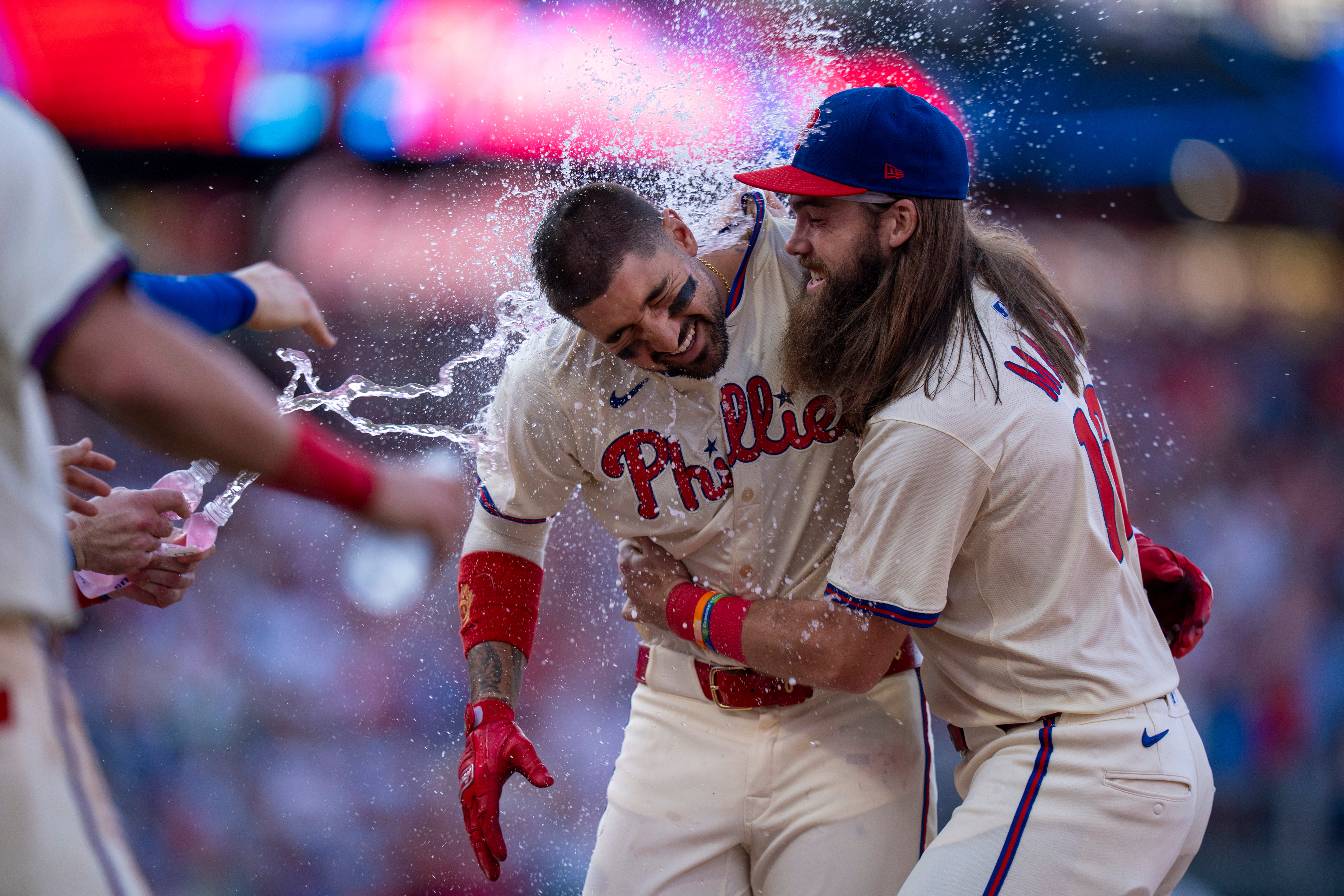 Philadelphia Phillies' Nick Castellanos, left, celebrates with Brandon Marsh, right, and other teammates after driving in the winning run during the 10th inning of a baseball game against the Minnesota Twins, Sunday, Sept. 28, 2025, in Philadelphia.