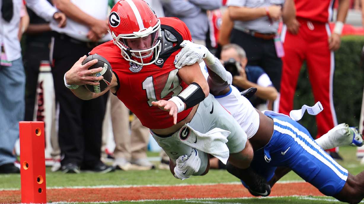Georgia quarterback Gunner Stockton (14) dives in for a touchdown during the first half of an NCAA college football game against Kentucky, Saturday, Oct. 4, 2025, in Athens, Ga.