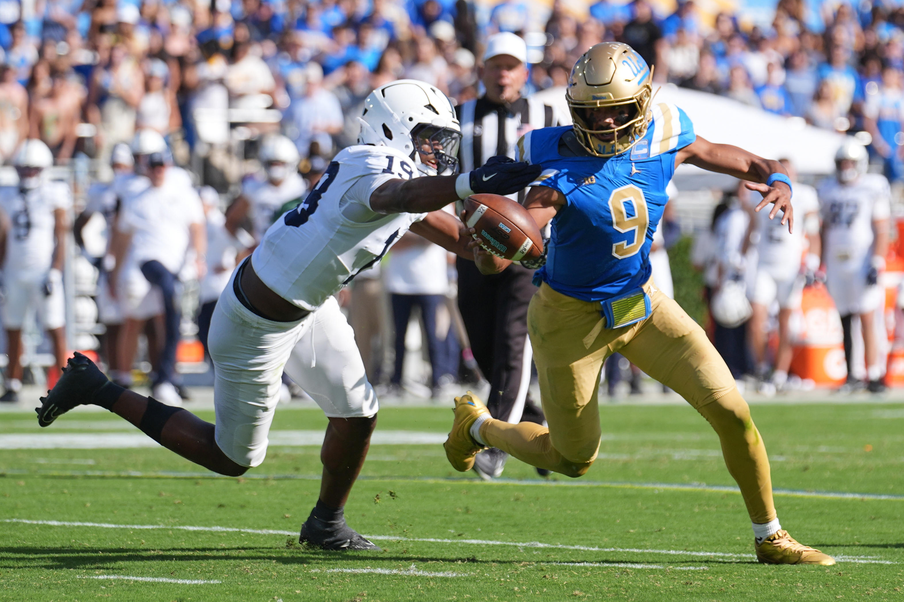UCLA quarterback Nico Iamaleava (9) runs past Penn State defensive end Chaz Coleman (19) during the second half of an NCAA college football game Saturday, Oct. 4, 2025, in Pasadena, Calif.
