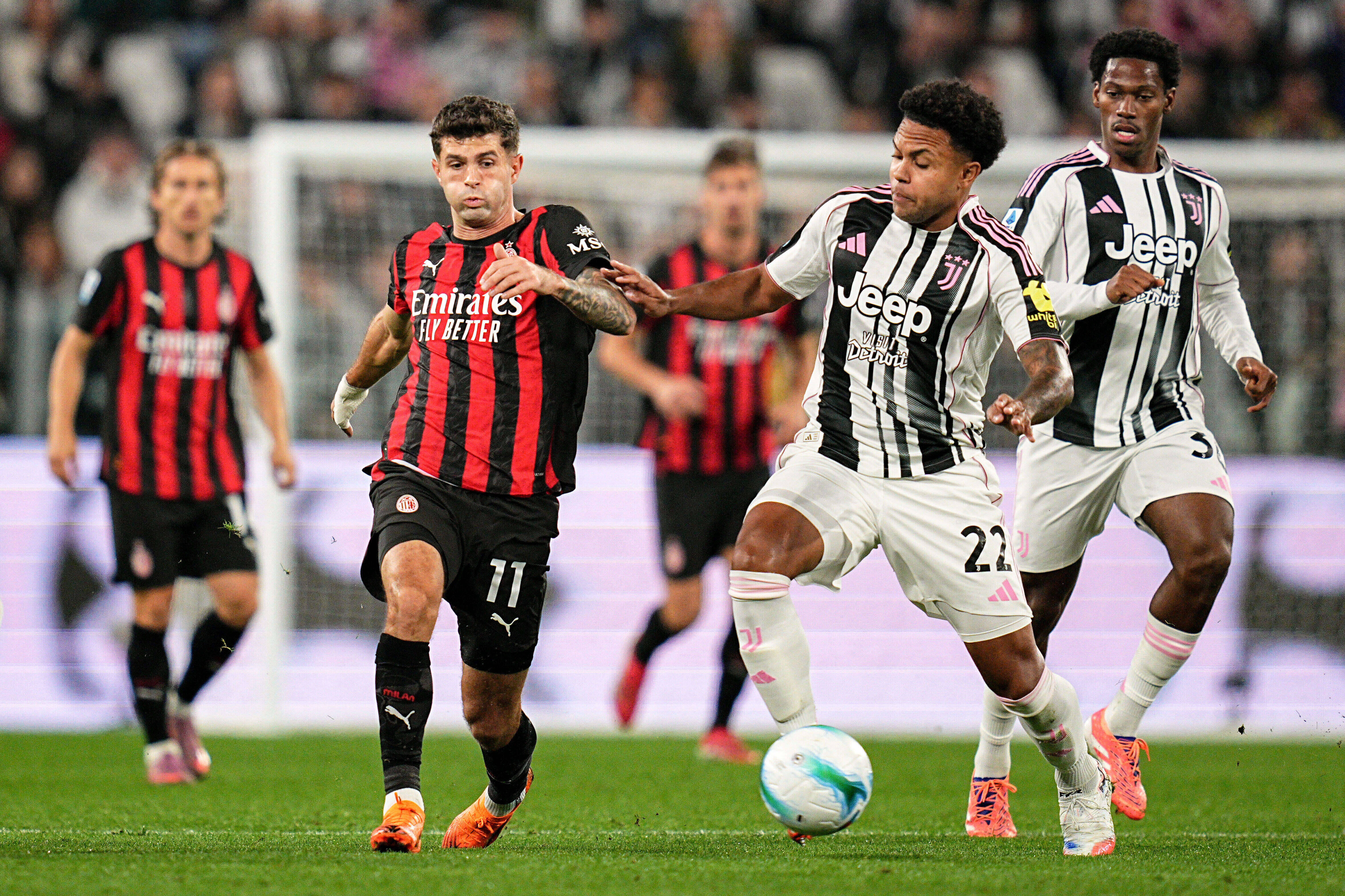 AC Milan's Christian Pulisic, center left, fights for the ball with Juventus' Weston McKennie during the Italian Serie A soccer match between Juventus and Milan at the Allianz Stadium in Turin, Italy, Sunday, Oct. 5, 2025.