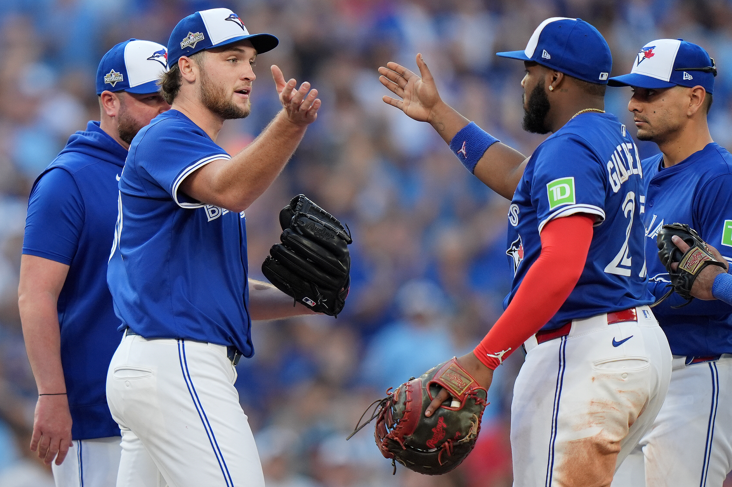 Toronto Blue Jays pitcher Trey Yesavage, front left, celebrates with teammate Vladimir Guerrero Jr., front right, after being pulled from the mound by manager John Schneider, back left, during the sixth inning of Game 2 of baseball's American League Division Series against the New York Yankees in Toronto, Sunday, Oct. 5, 2025.