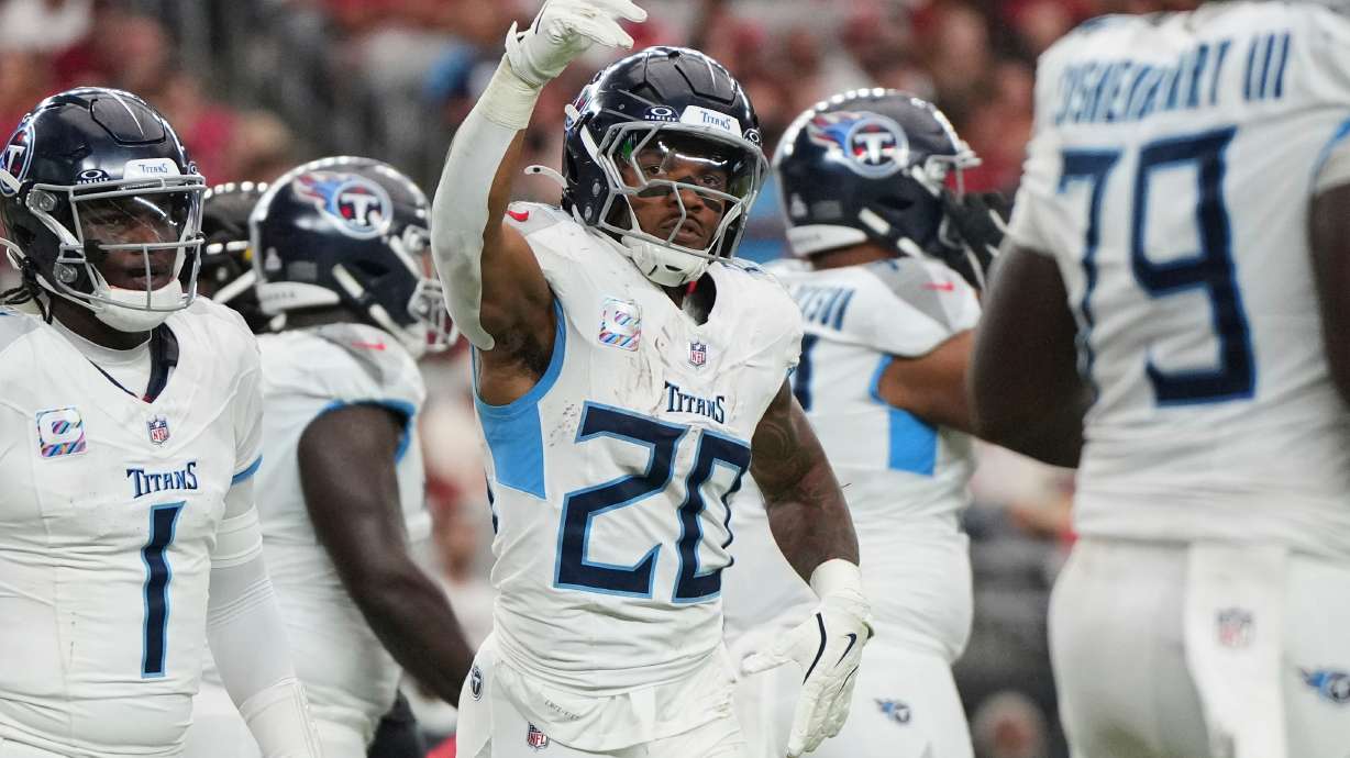Tennessee Titans running back Tony Pollard (20) celebrates his touchdown during the second half of an NFL football game against the Arizona Cardinals, Sunday, Oct. 5, 2025, in Glendale, Ariz.